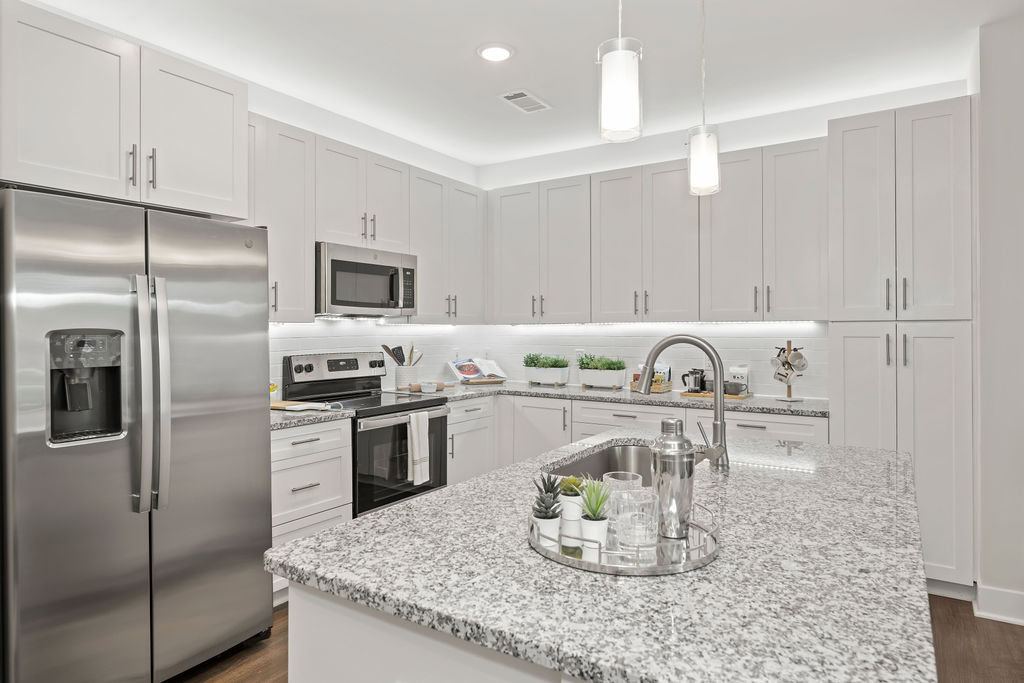 A kitchen with a kitchen island in an apartment at the Courtney Ridge apartments in Charlotte, NC
