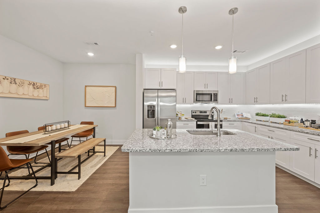 A kitchen, kitchen island and dining area in an apartment at the Courtney Ridge apartments in Charlotte, NC
