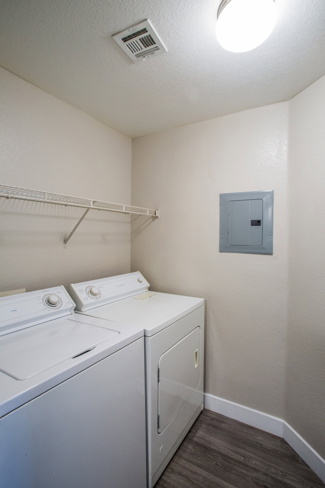 A laundry area with shelf space, a washer and a dryer in a Monaco Park apartment for rent in Spring Valley