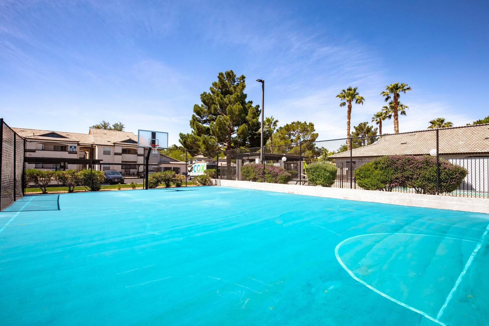 A bright blue basketball court at the Xander 3900 apartments in Centennial Hills, Las Vegas