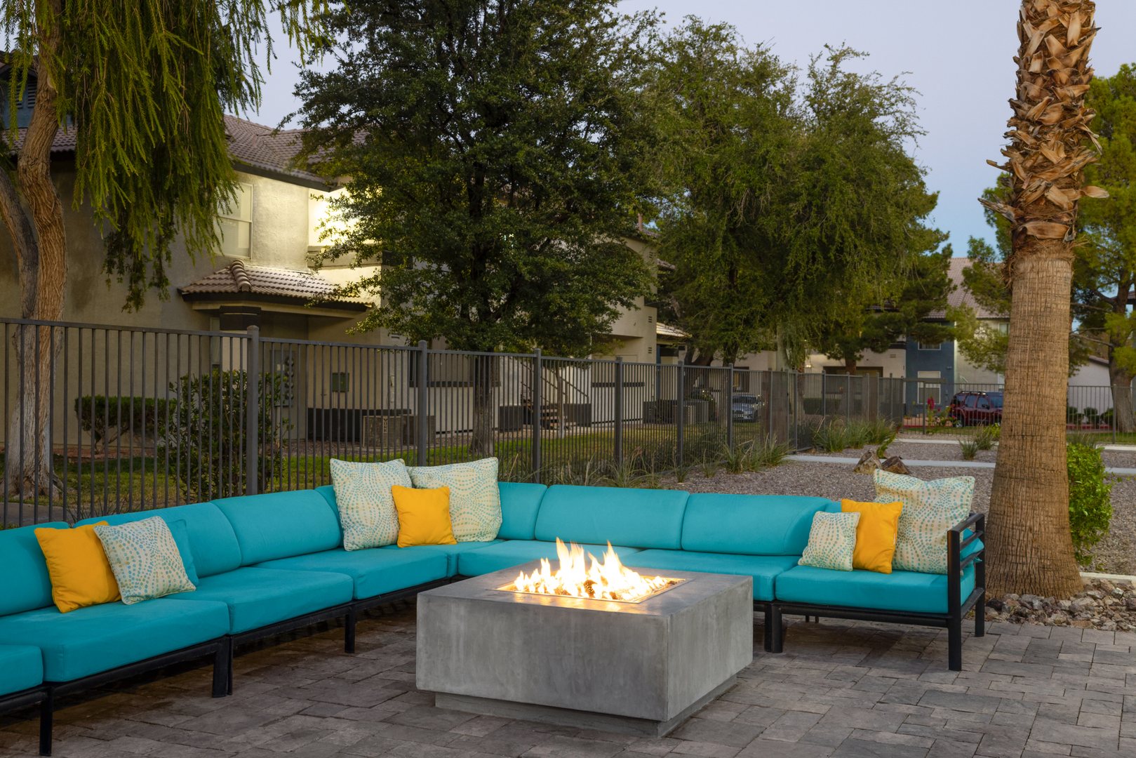 A modern firepit in front of an L shaped outdoor chair at the Xander 3900 apartments in Las Vegas