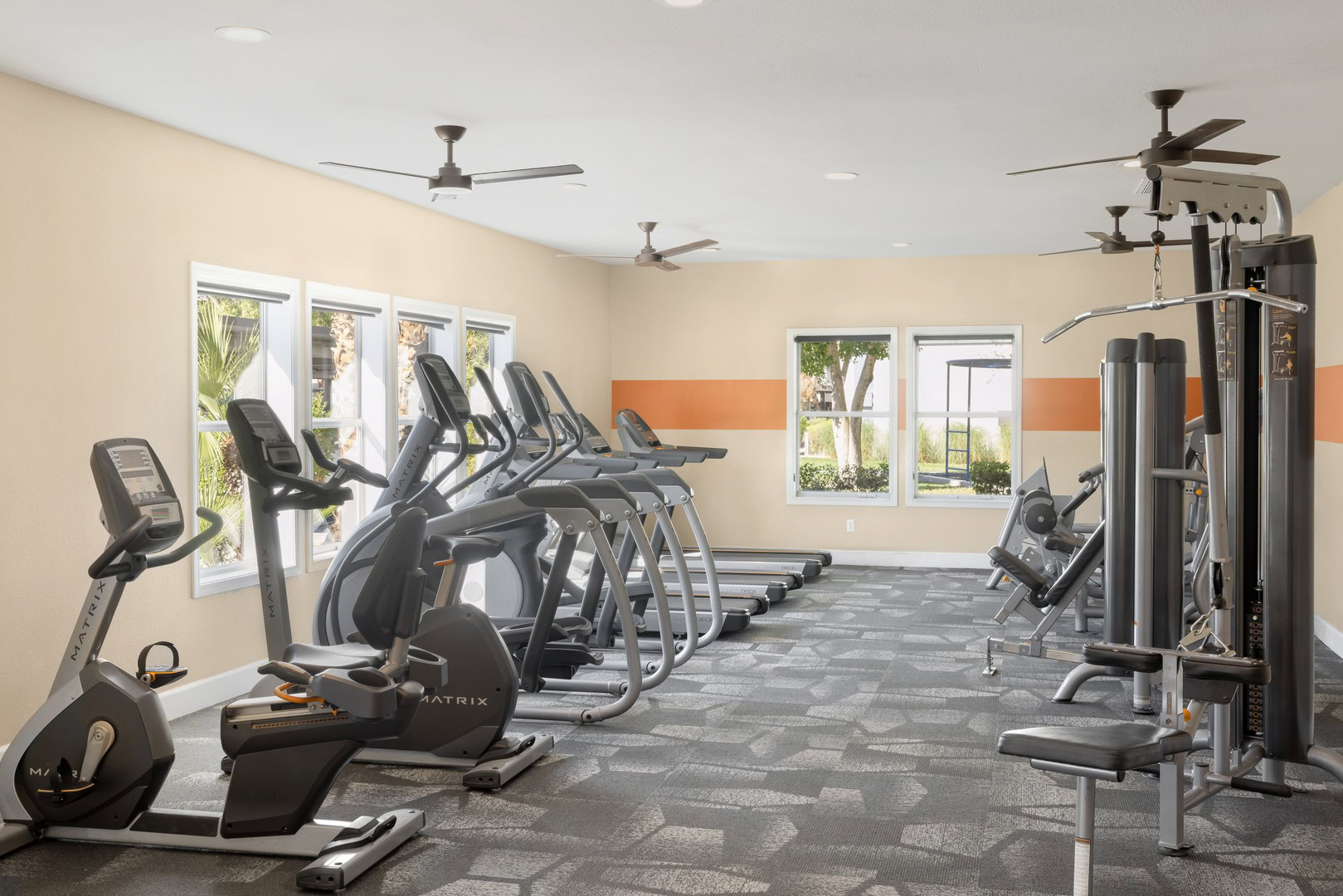 A fitness center with stationary bikes, elipticals and treadmills at Xander 3900 apartments in Northwest Las Vegas