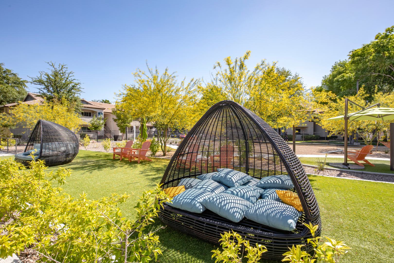 A woven outdoor day bed in a garden at the Xander 3900 apartments near centennial hills las vegas