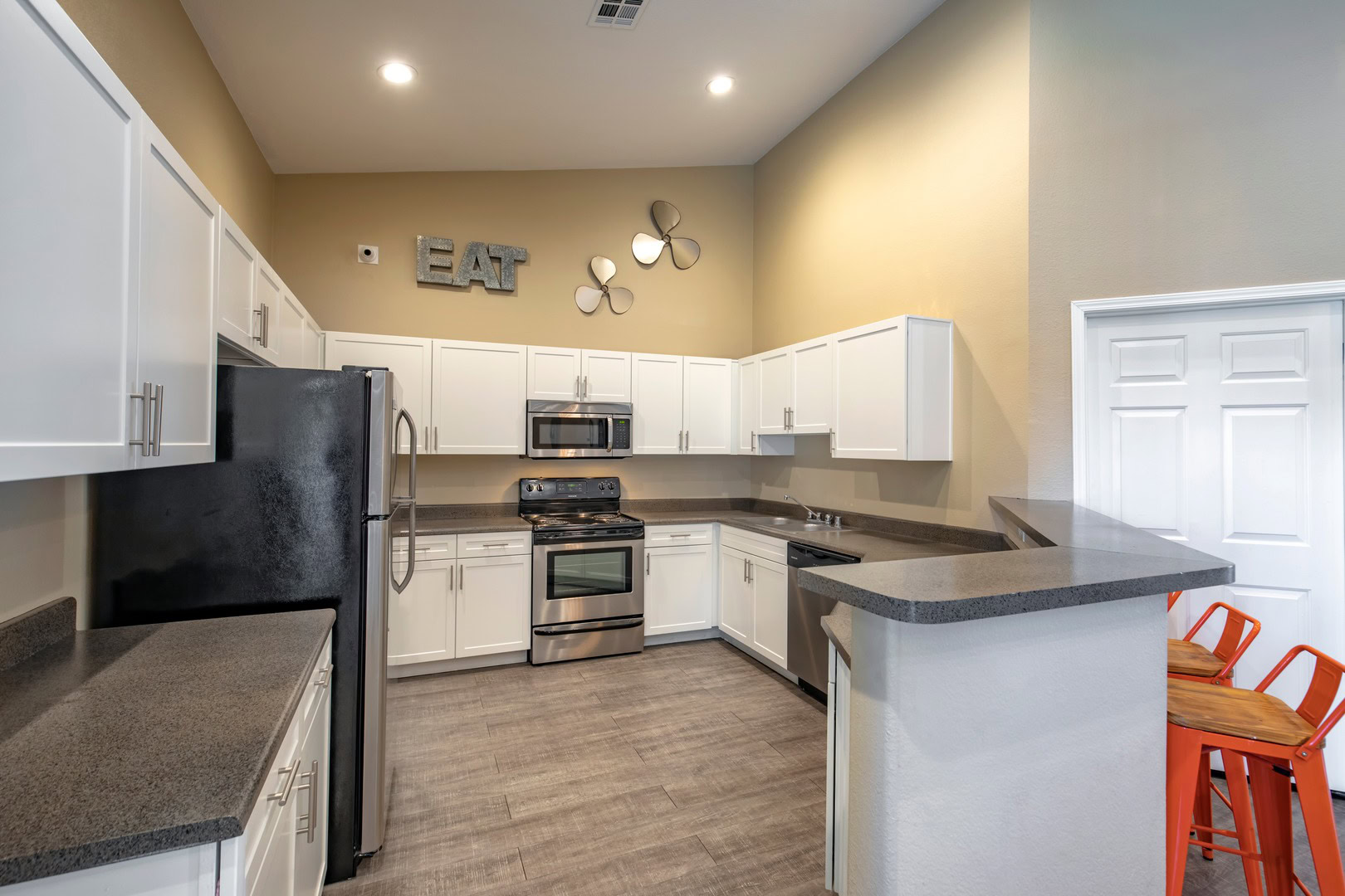 A kitchen with a high counter for dining at the Xander 3900 apartments at Centennial Hills