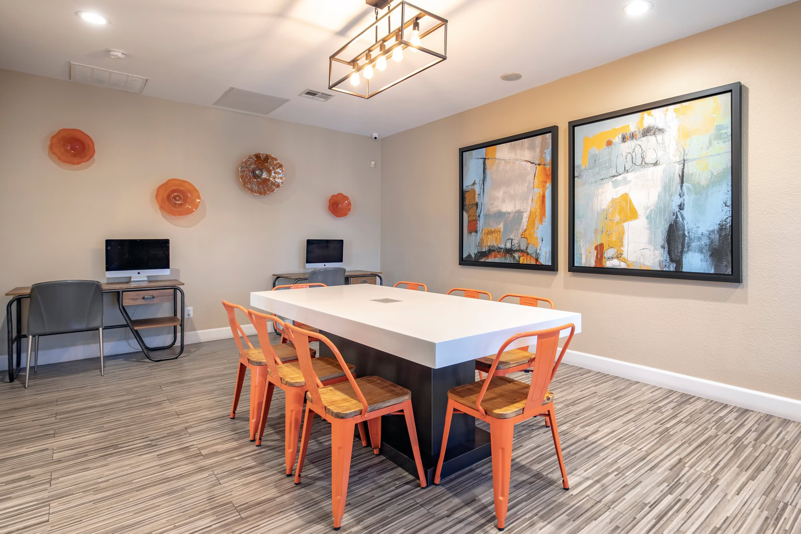 A shared work table and two computer stations in a lounge at the Xander 3900 apartments in Northwest Las Vegas