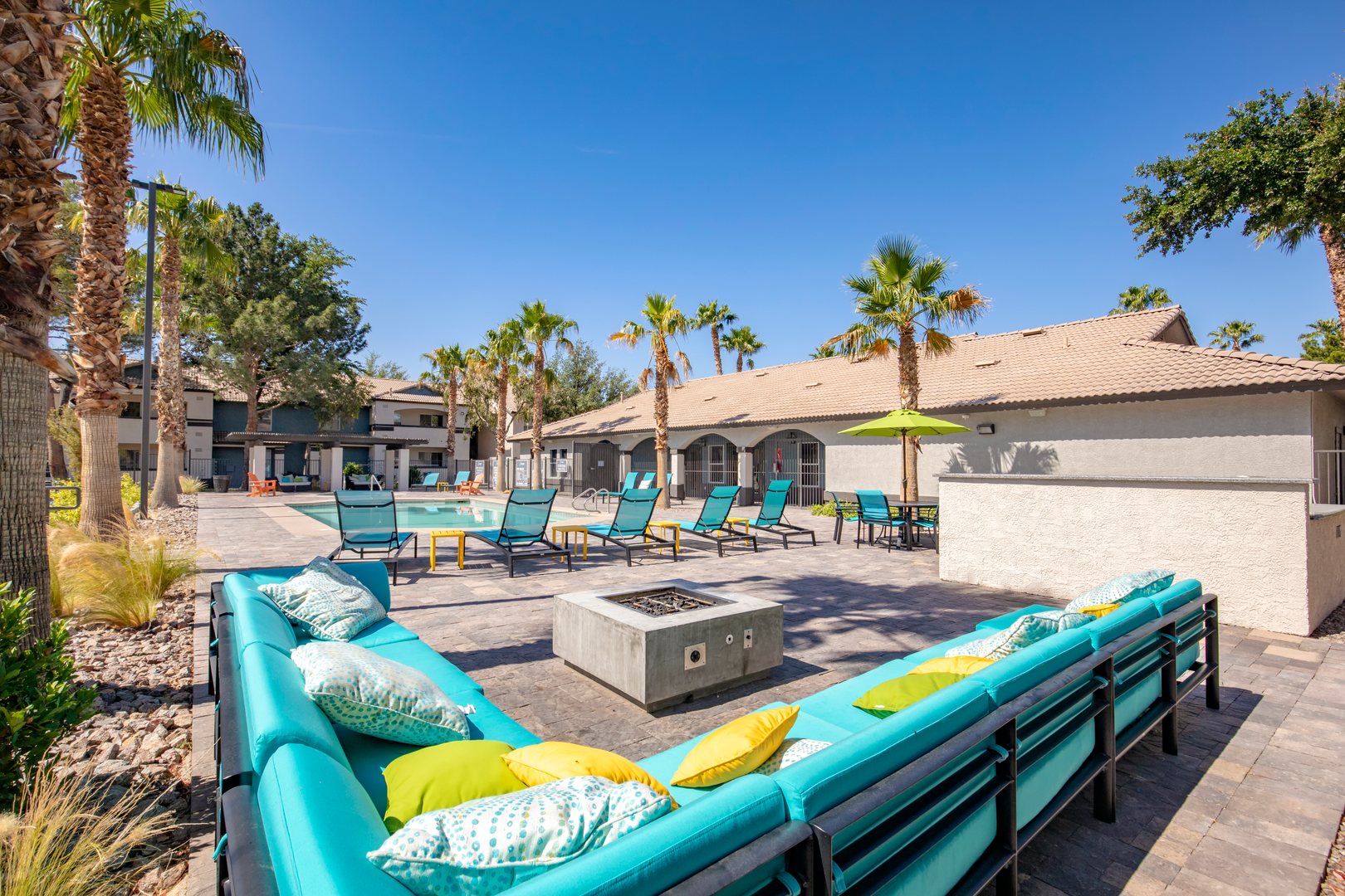 A lounge and fire put by the pool at the Xander 3900 apartments for rent in Northwest Las Vegas