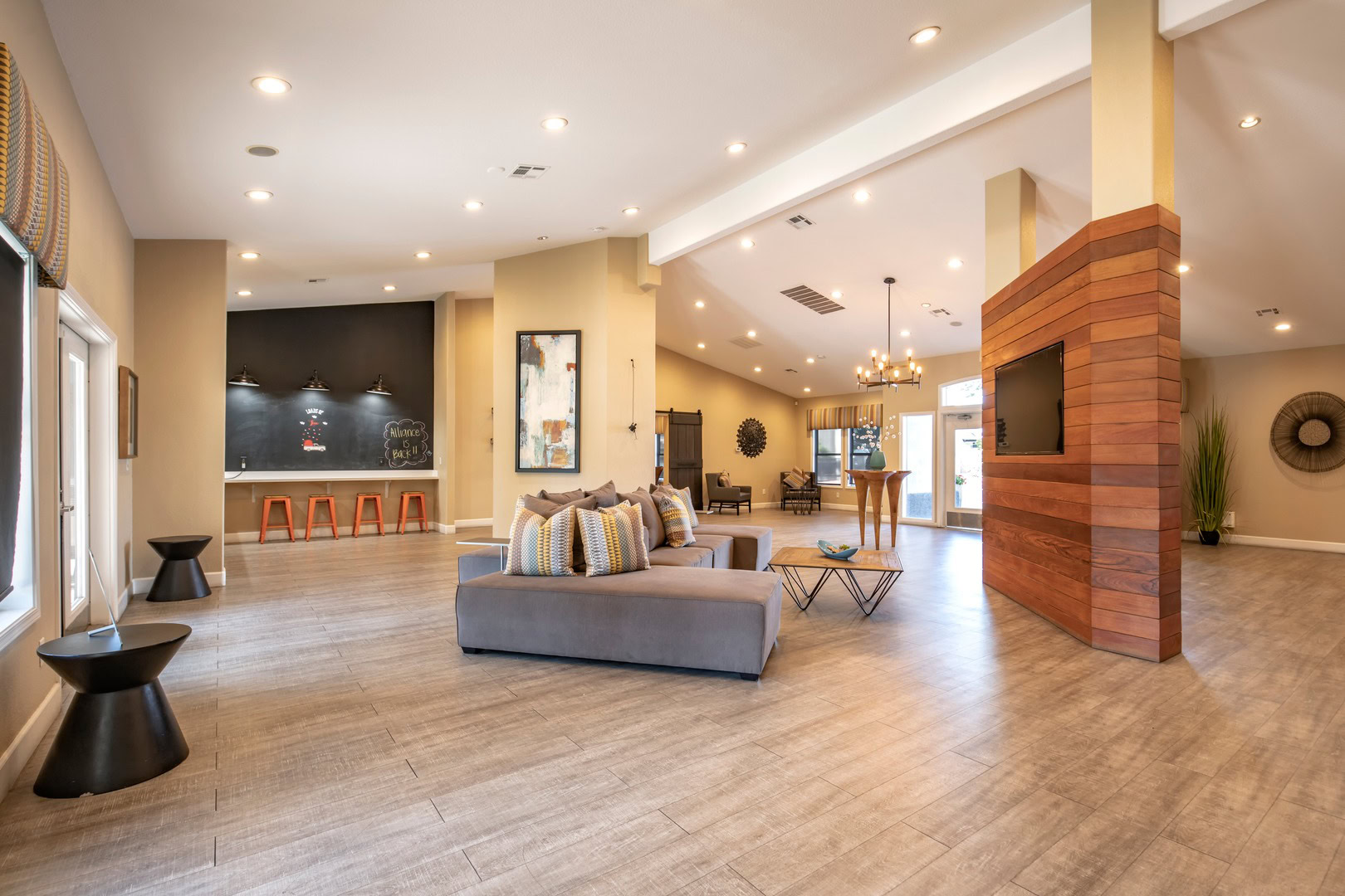 A lounge with a bar area and a TV area at the Xander 3900 apartments in Northwest Las Vegas