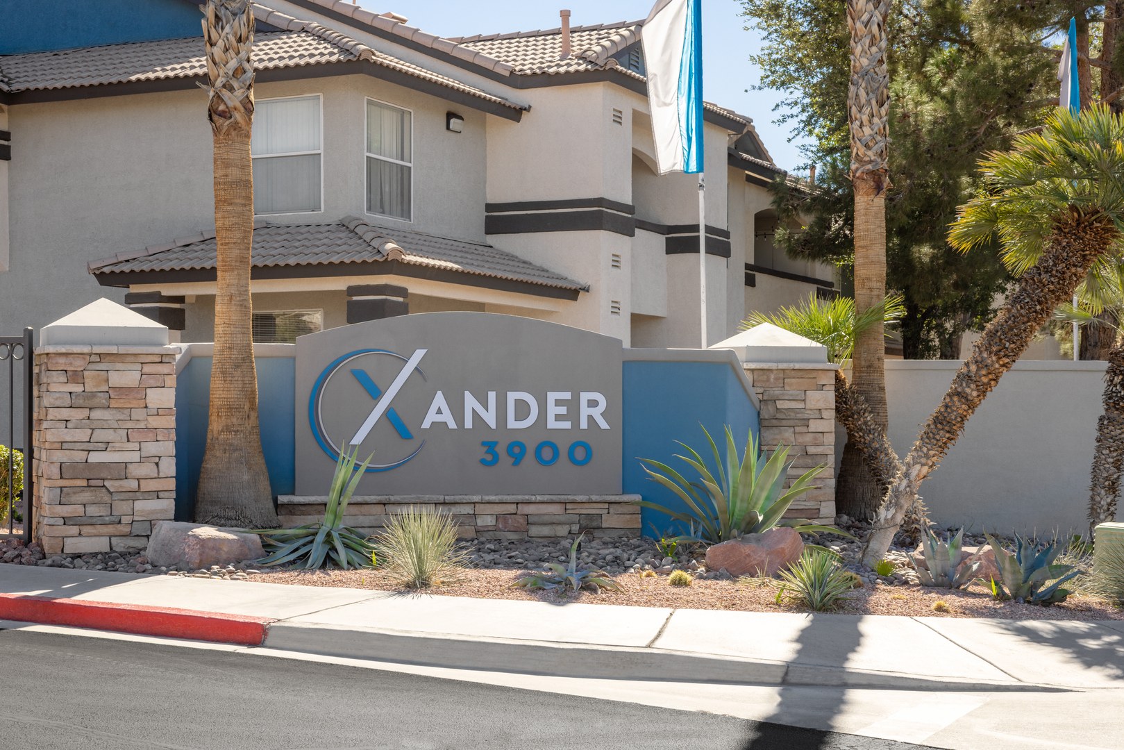 The entrance with a blue sign to Xander 3900 apartments near Centennial Halls, Las Vegas
