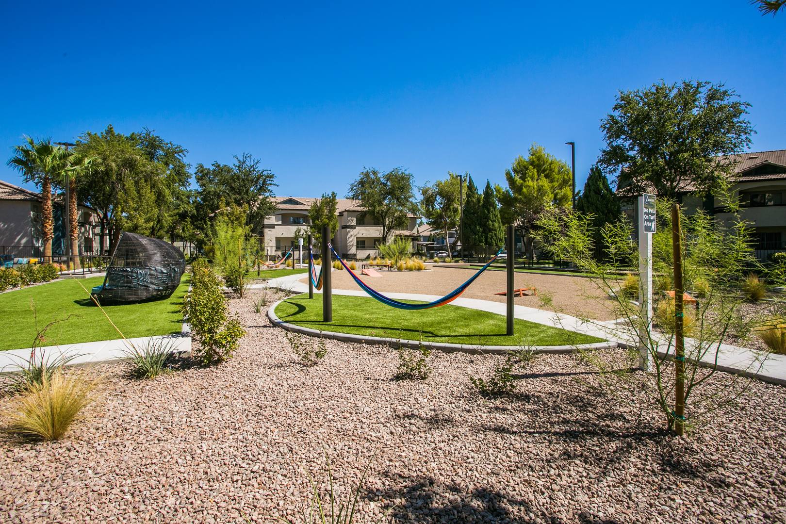 A game lawn outdoor recreational space featuring hammoks and day beds at the Xander 3900 apartments in northwest Las Vegas