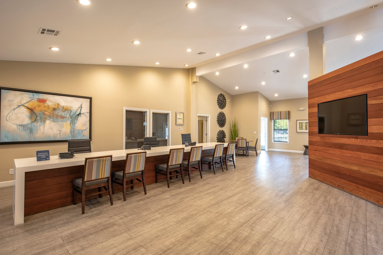 A lounge with a long front desk for the leasing office at the Xander 3900 apartments for rent in Centennial Hills