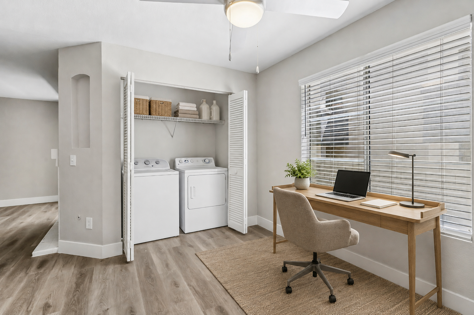 Virtually staged flex space at Vintage Pointe with an in-home washer and dryer, desk, chair, and large window.