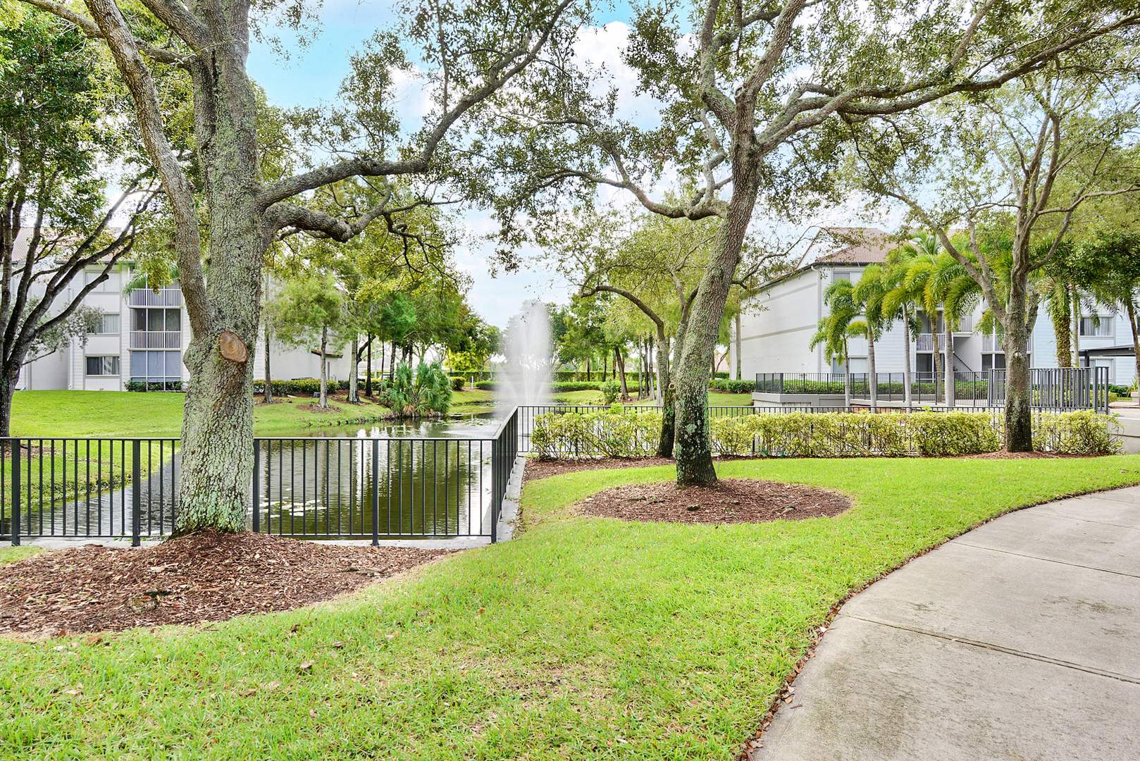 A walking path in a courtyard at Sabal Pointe apartments in South Florida