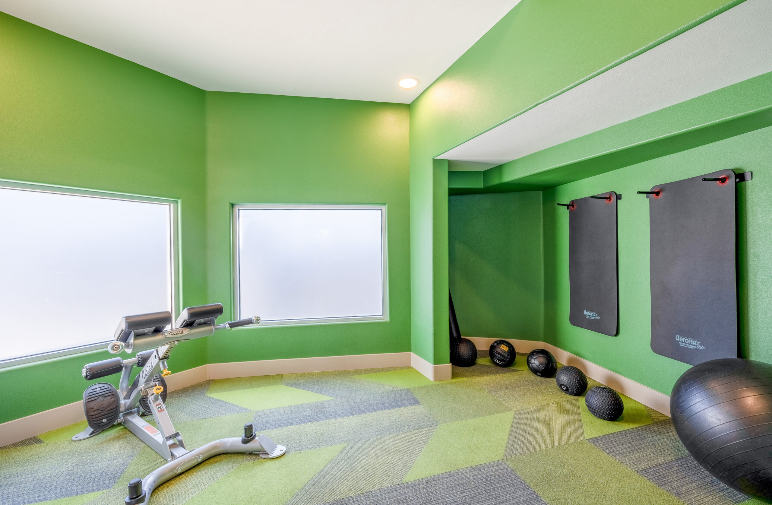 A studio space with fitness balls, mounted matts and frosted windows at The Met apartment in Northwest Las Vegas