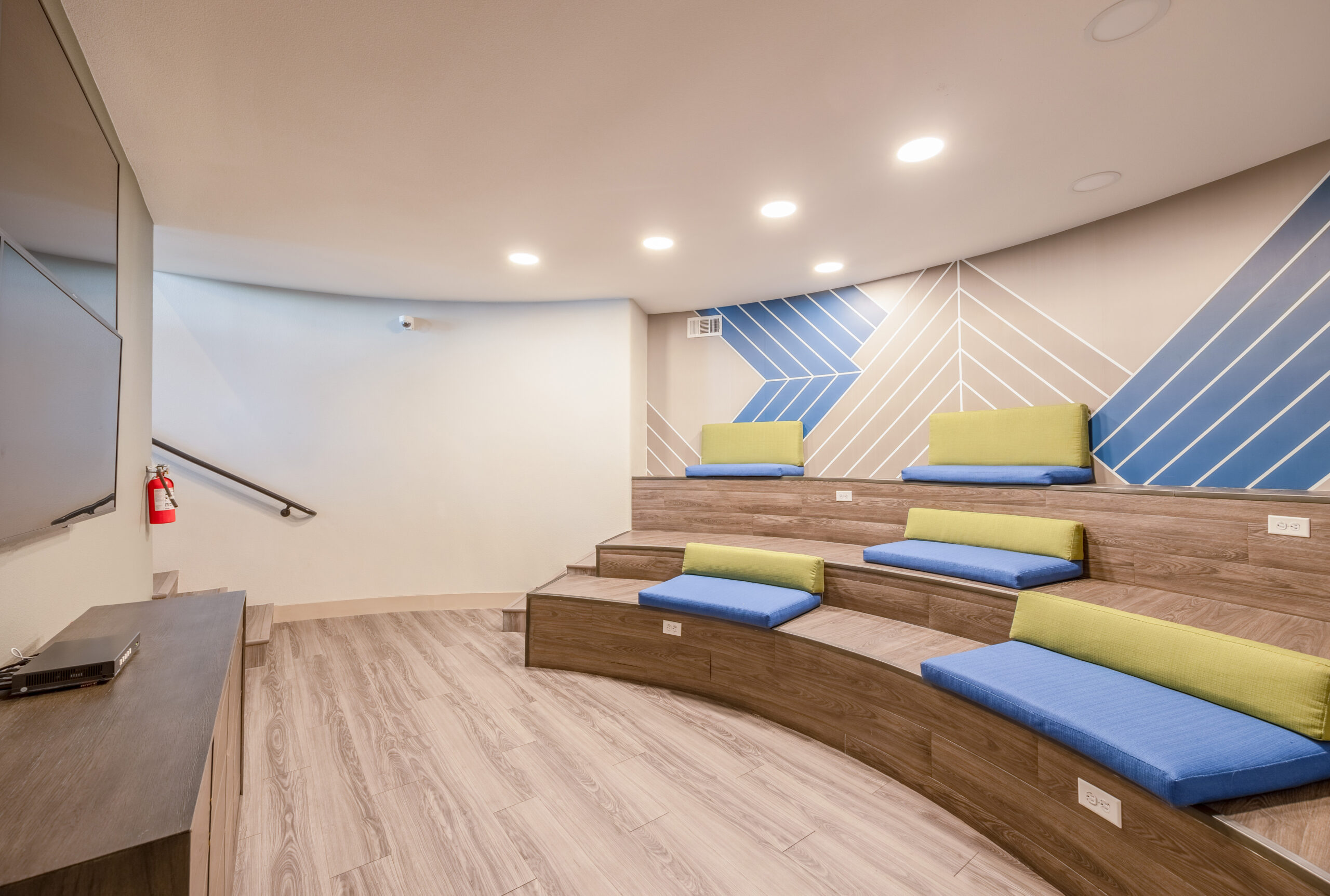 A movie theatre with ampitheatre stair seating with cushions at The Met Las Vegas apartments in Northwest Las Vegas