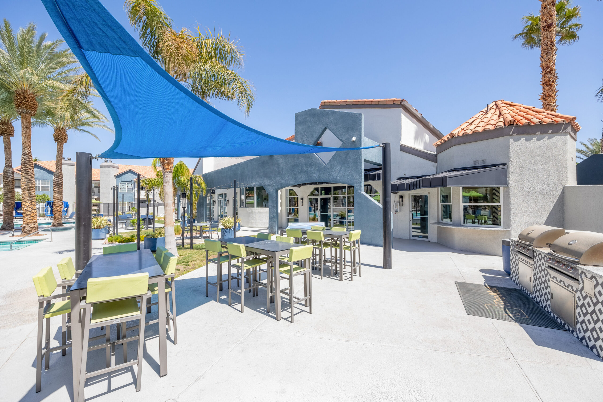 Outdoor dining tables next to the grilling station at The Met apartments in Northwest Las Vegas