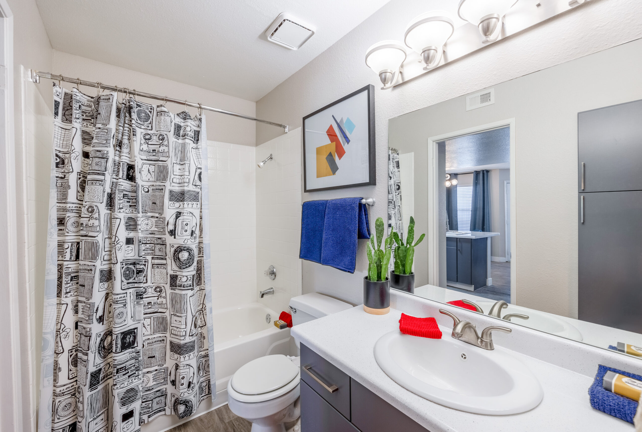 A bathroom with extra storage, hardwood floors and a tub with a shower head at The Met Las Vegas apartments