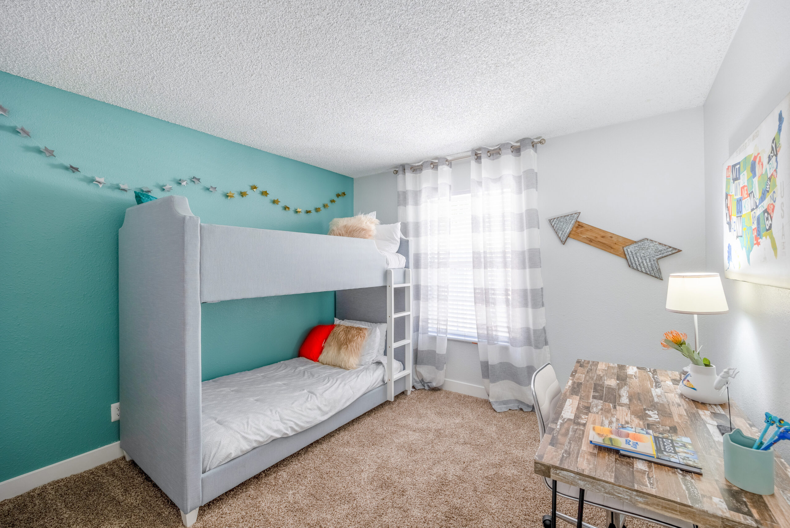 A bedroom with carpet flooring and a large window at The Met Las Vegas apartments in Las Vegas