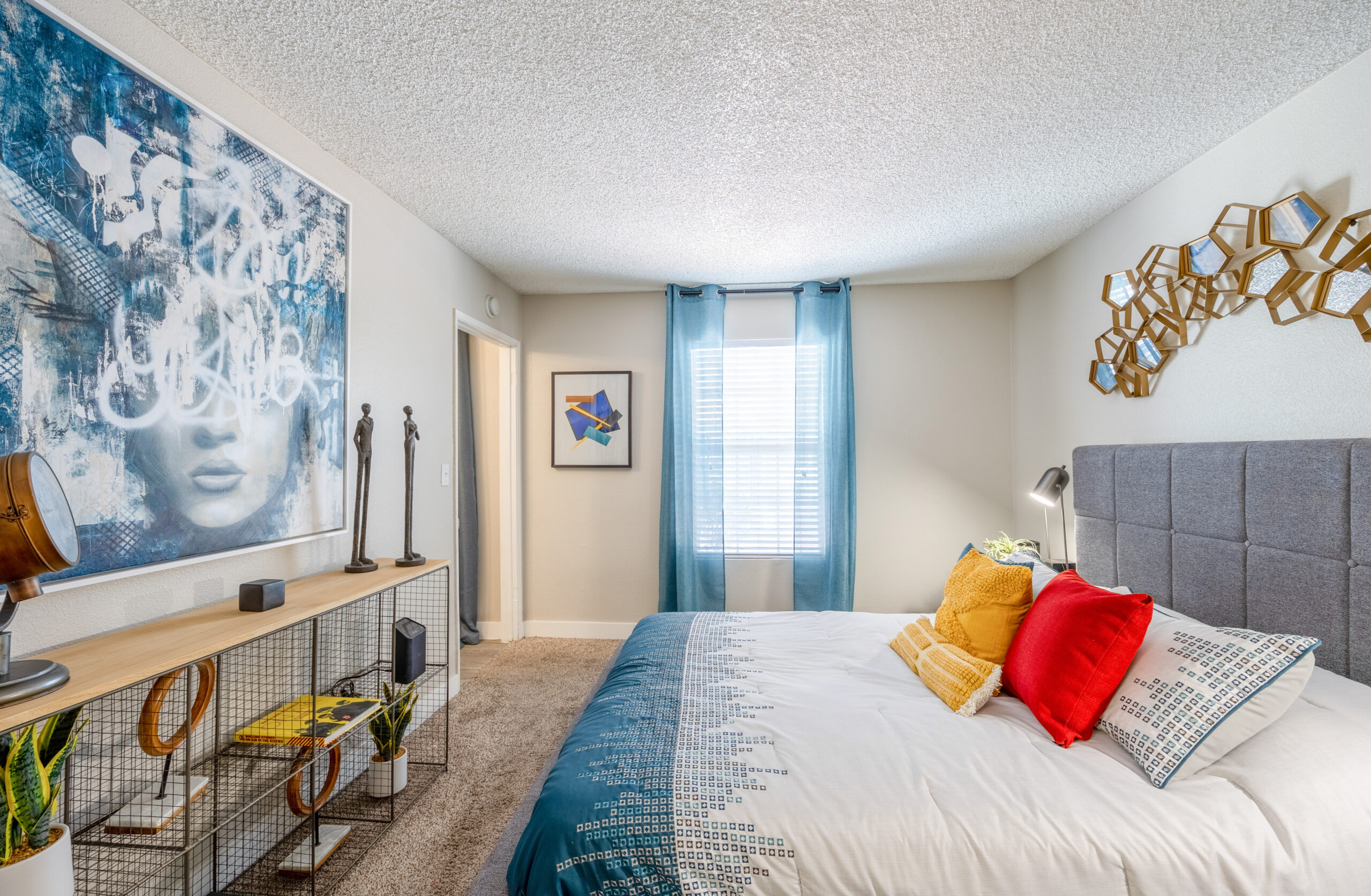 A carpeted bedroom with a walk-in closet and a window at The Met apartments in Las Vegas