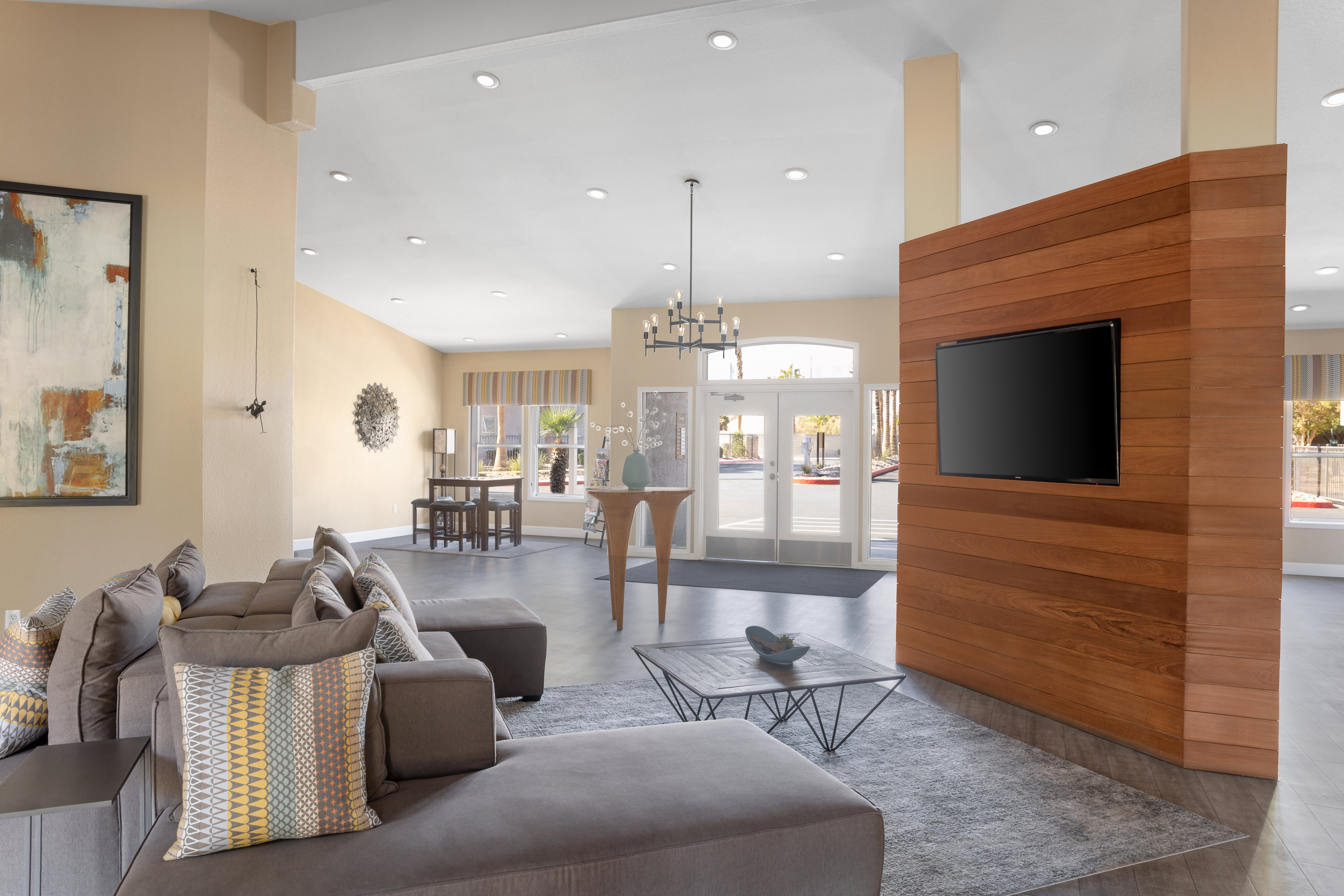 A lounge with a mounted tv on a partition wall in a spacious lobby at Xander 3900 apartments in Las Vegas