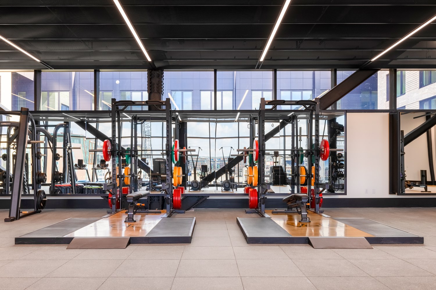 Inside Vela's fitness center top-of-the-line strength training equipment and plentiful light.