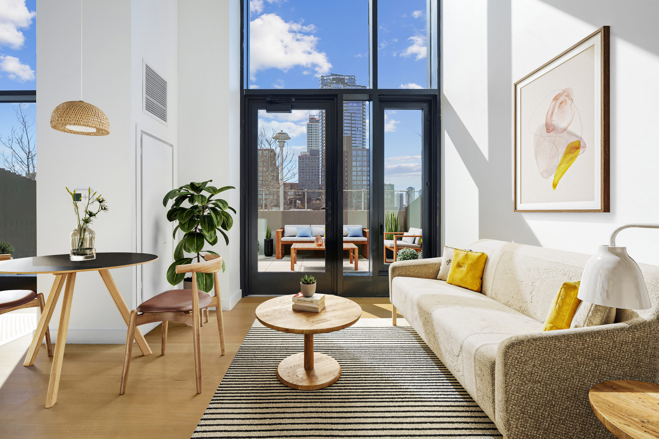 Studio apartment with dining, and living areas and a view of the outdoor terrace with furniture.