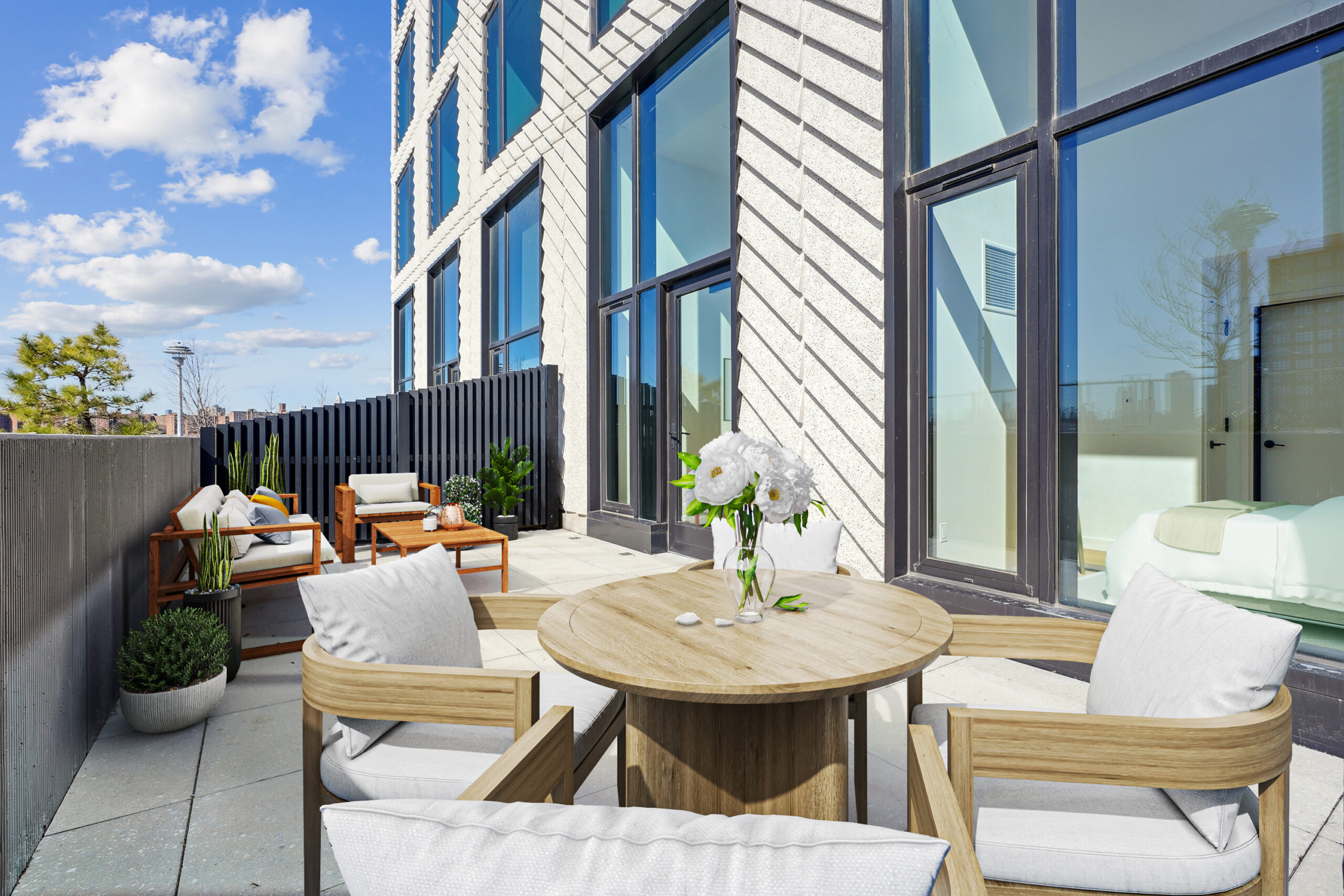 Private outdoor terrace at a studio apartment at Eagle + West with furniture.
