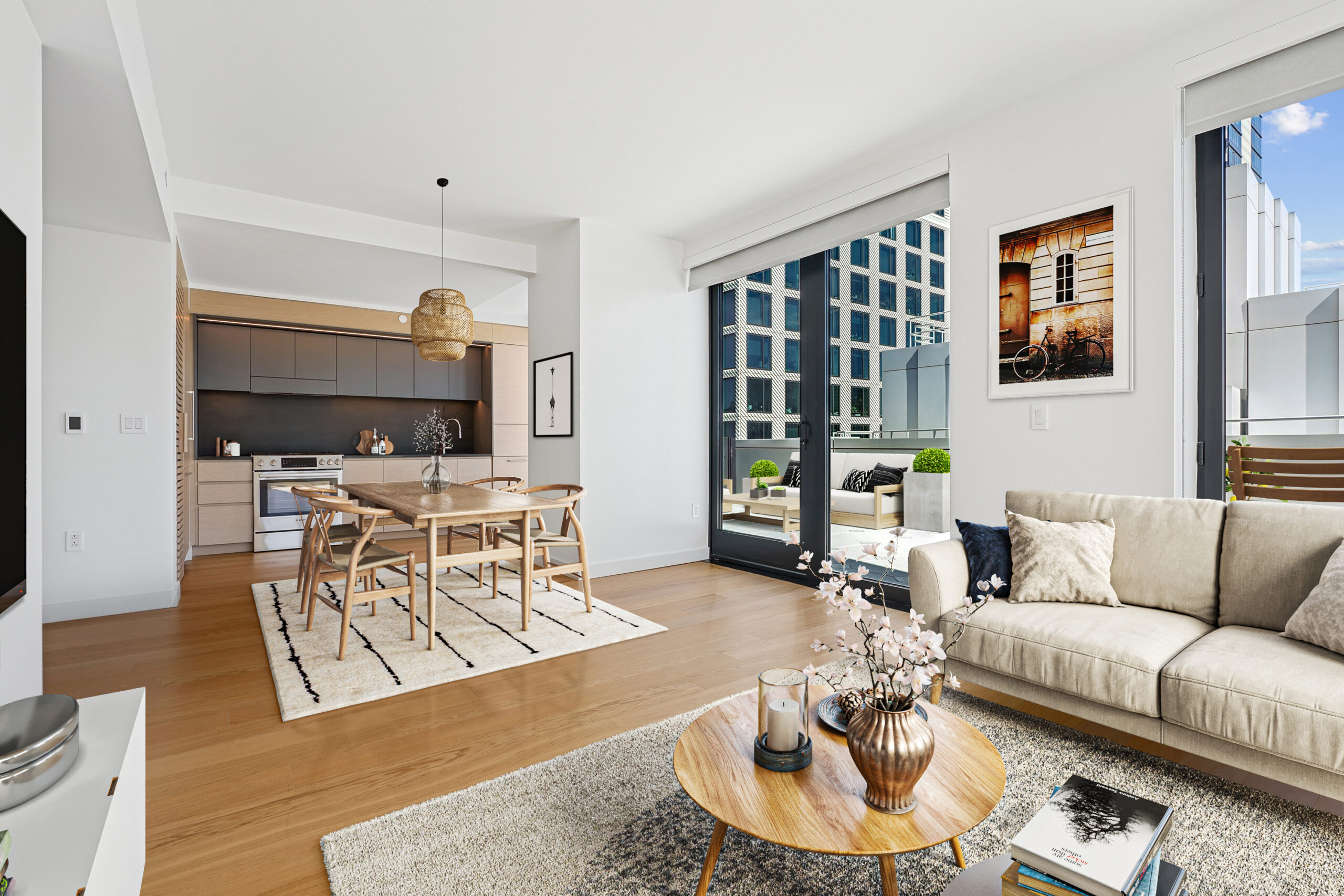 Modern kitchen, living, and dining areas with a view of the outdoor terrace