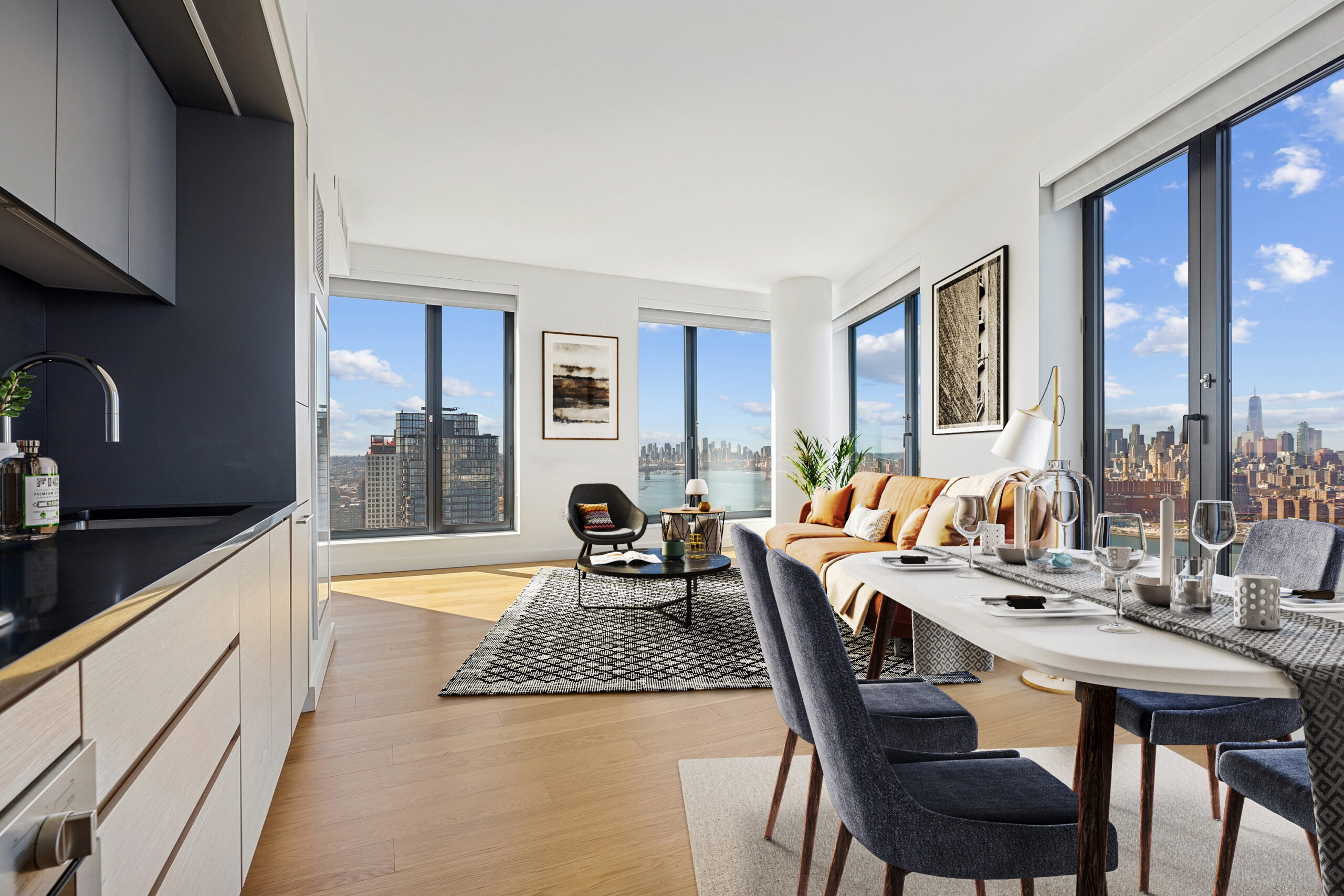 Modern kitchen, living and dining areas with city and water views