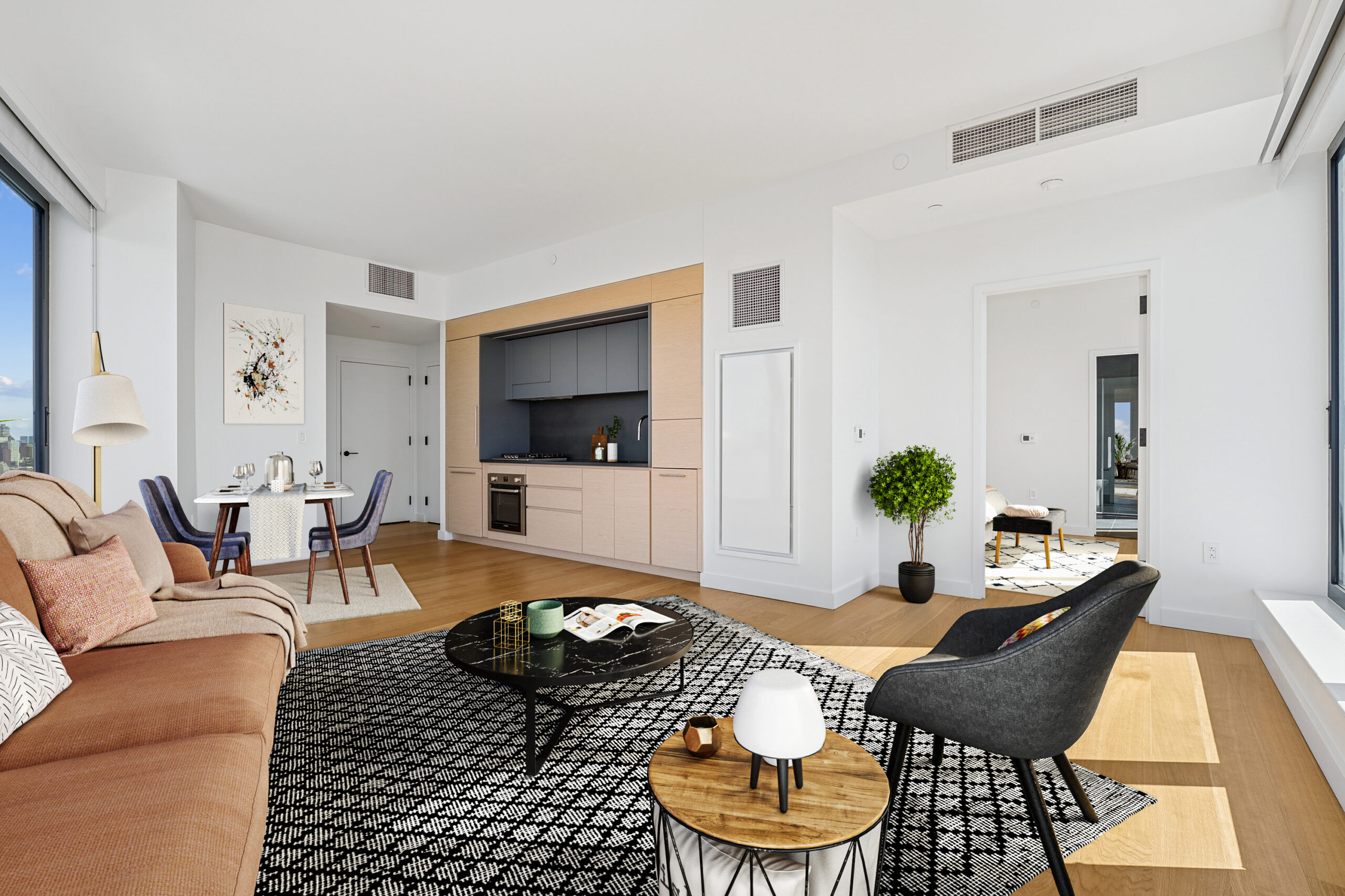 Modern living and dining area with a view into the bedroom