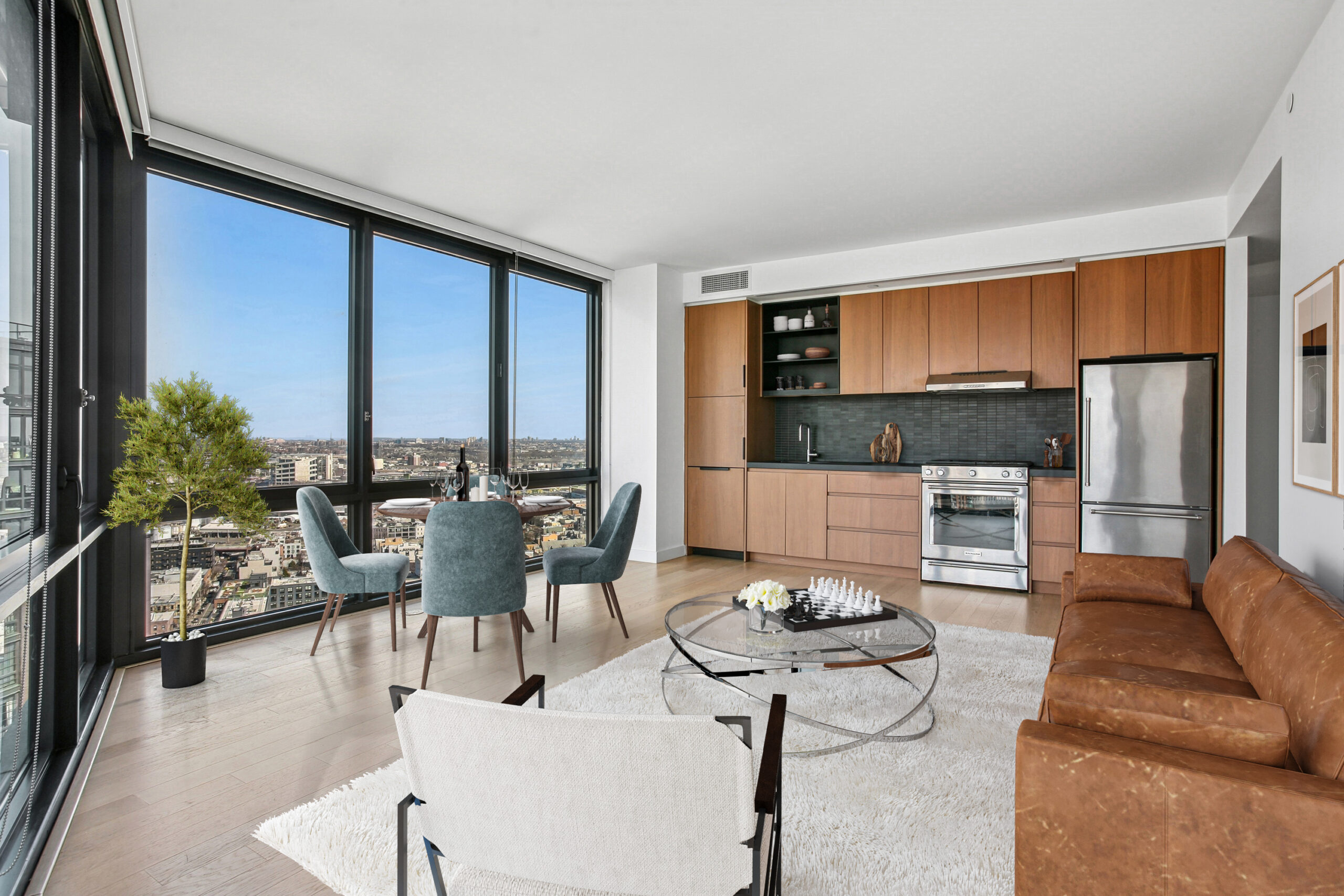 Spacious and modern apartment with city views from floor-to-ceiling windows, and modern cabinetry