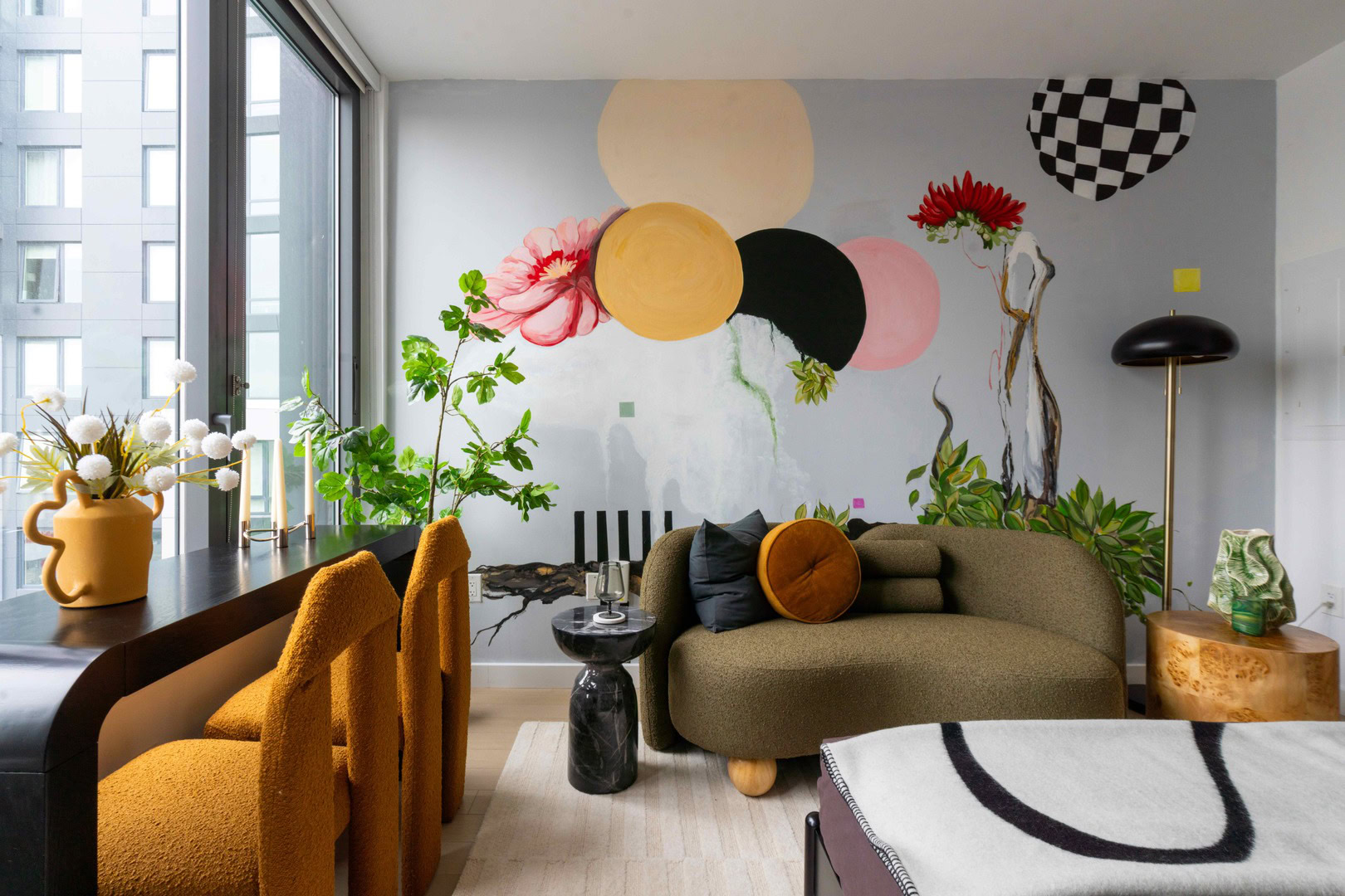 A modern apartment with a colorful mural on the wall.