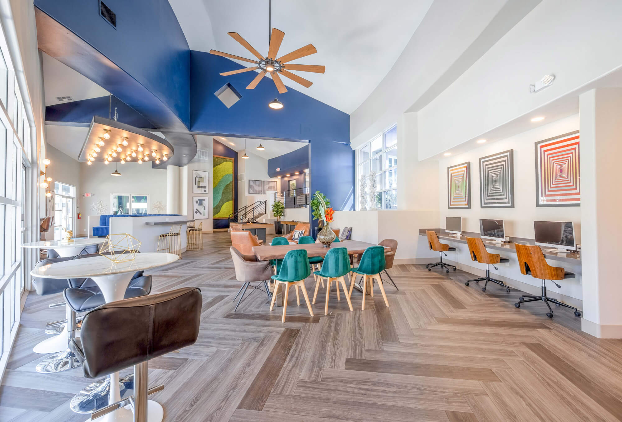 Resident clubhouse and coworking lounge with seating and workstations at The Met Las Vegas
Apartments.
