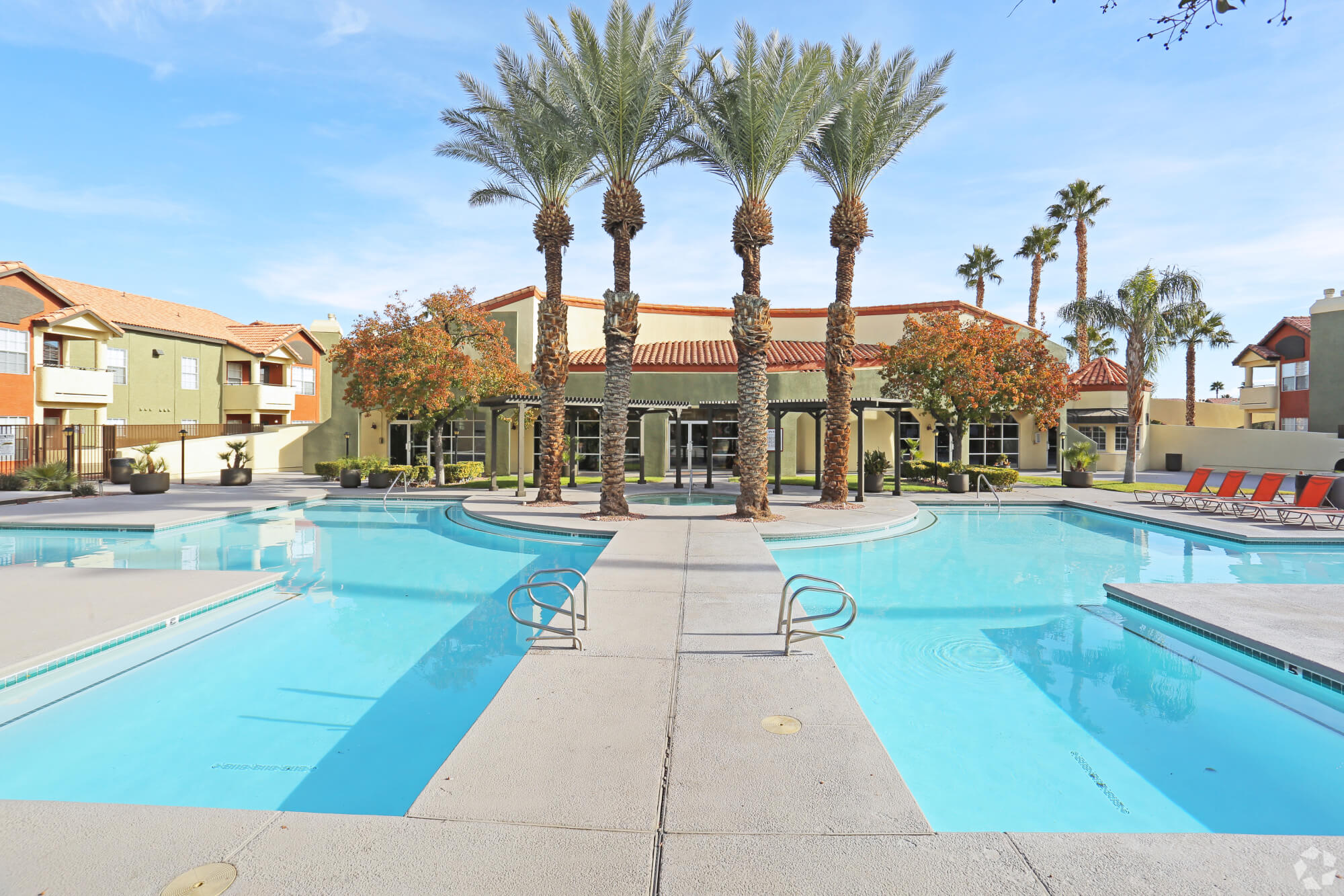 Central pool courtyard with palm trees and sun deck at The Met Las Vegas Apartments.