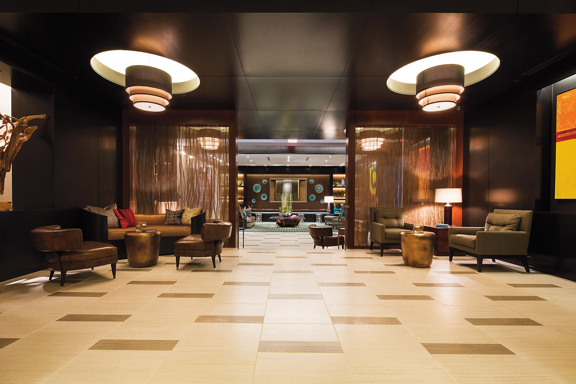 Elegant lobby at The Continental in downtown Dallas, Texas with stylish seating and warm lighting.