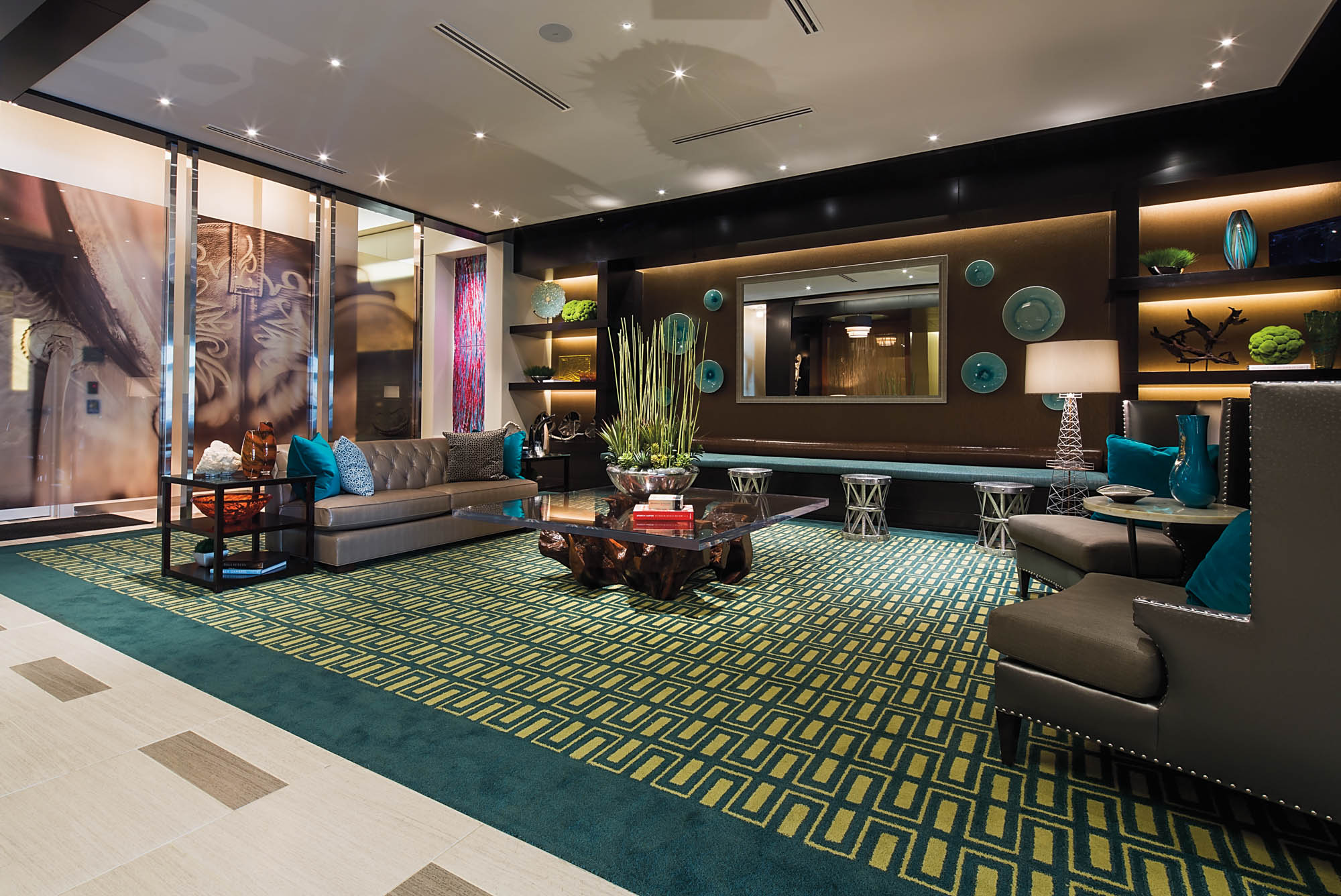 Vibrant lobby at The Continental apartments with housing in Dallas, Texas featuring a elegant furniture and bright blue accents