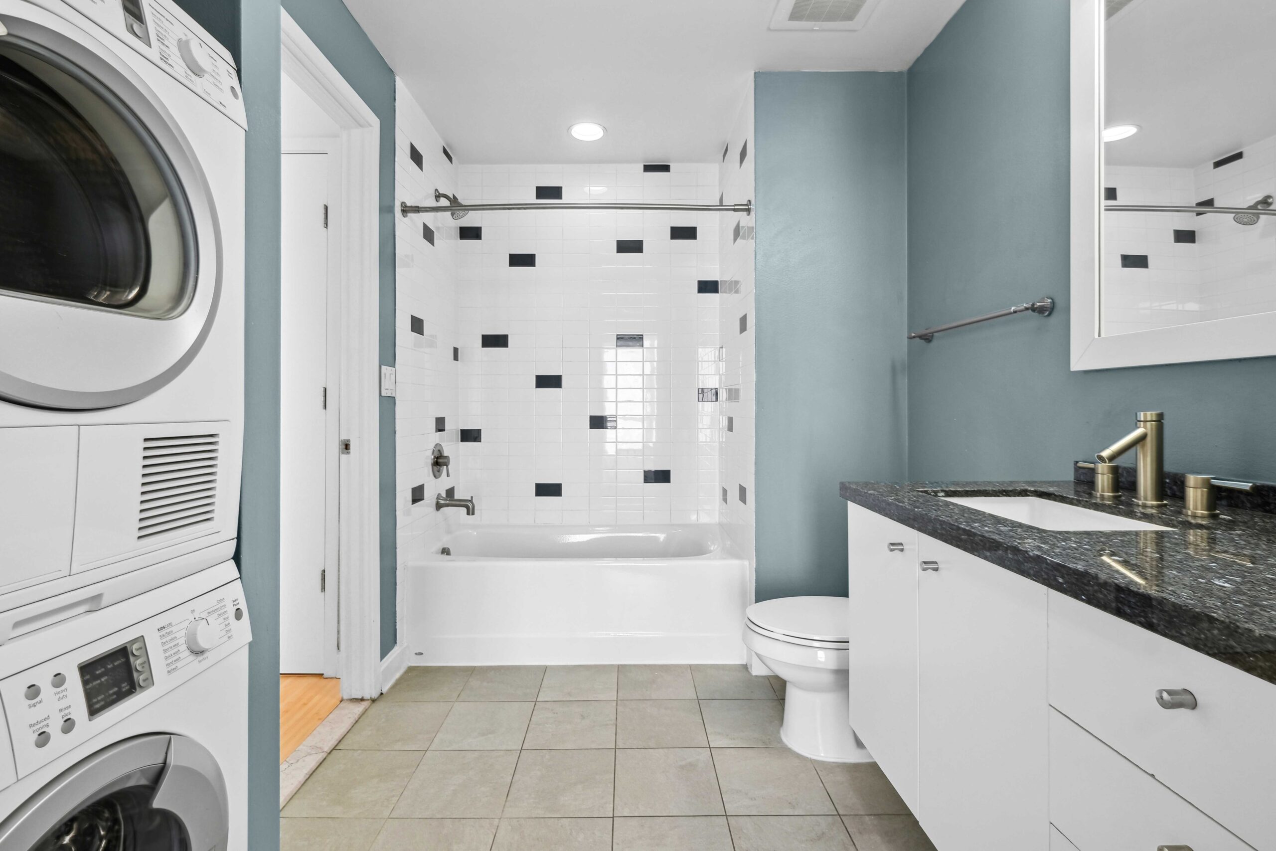 Spacious bathroom with an in unit washer and dryer in The Elements luxury apartment in Dallas Texas