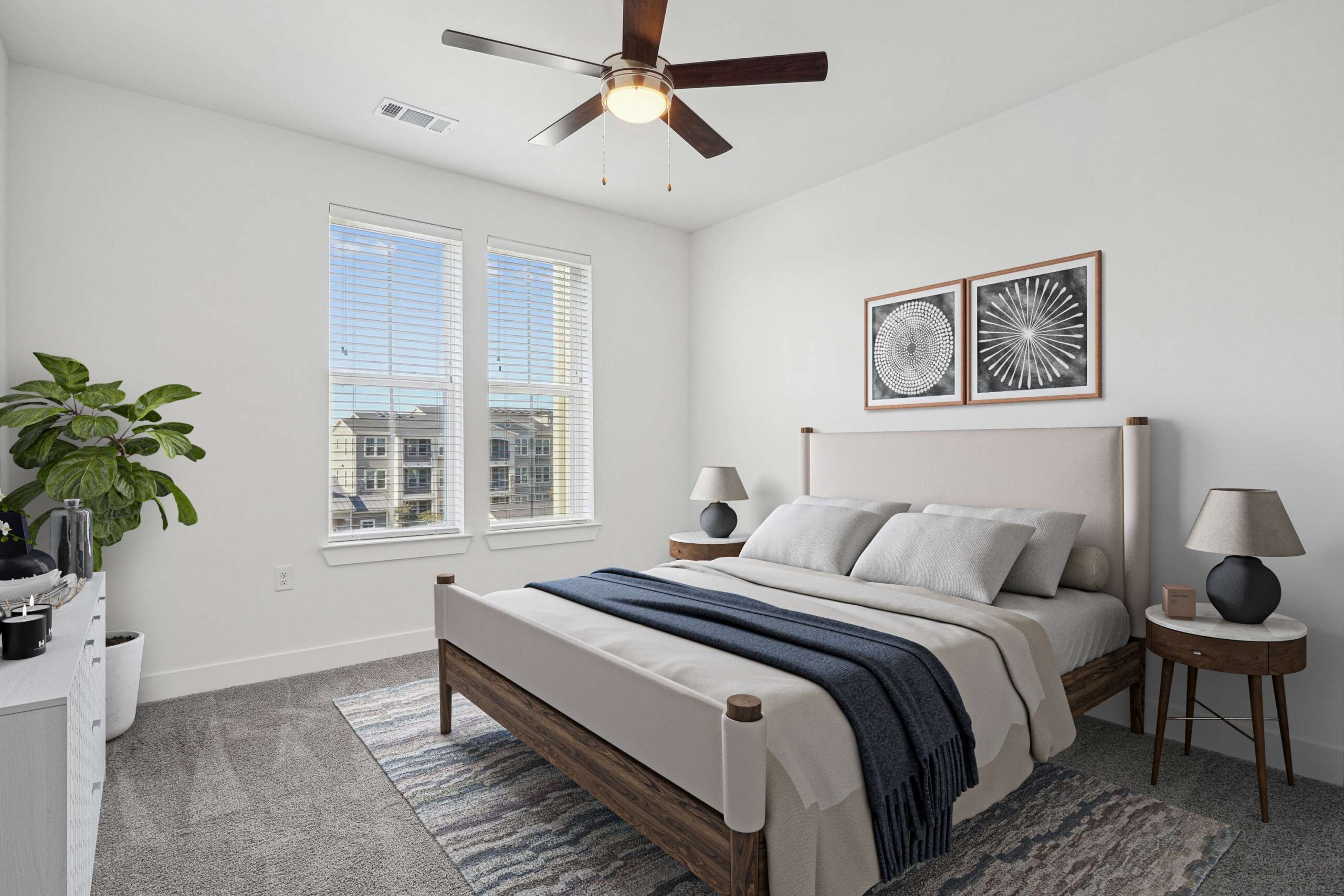 Bright apartment bedroom in Garland Texas, featuring large windows, modern decor, and a plush carpet under the bed