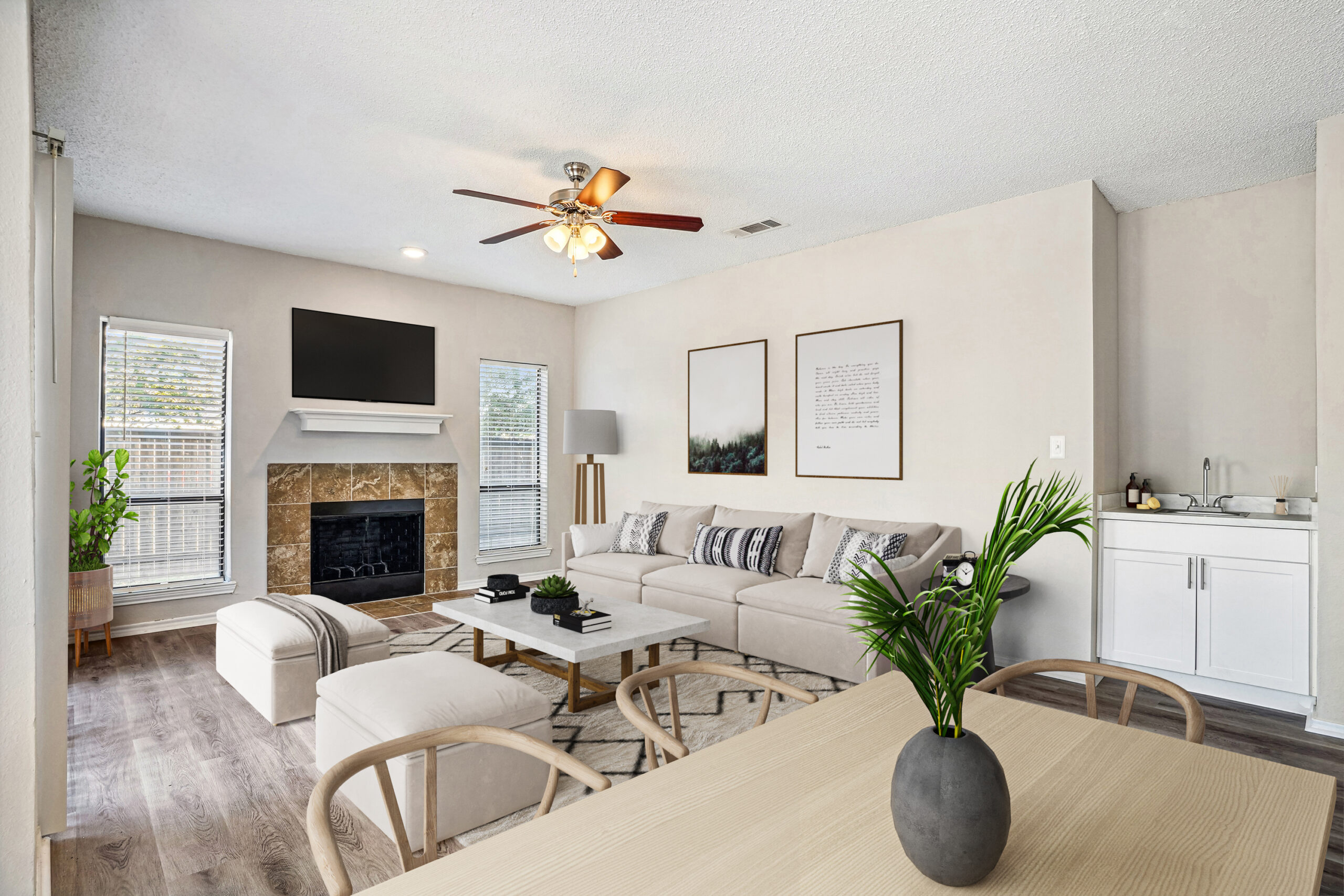 Modern apartment living room in Garland Texas, featuring a fireplace, wood-style floors, and contemporary furniture.