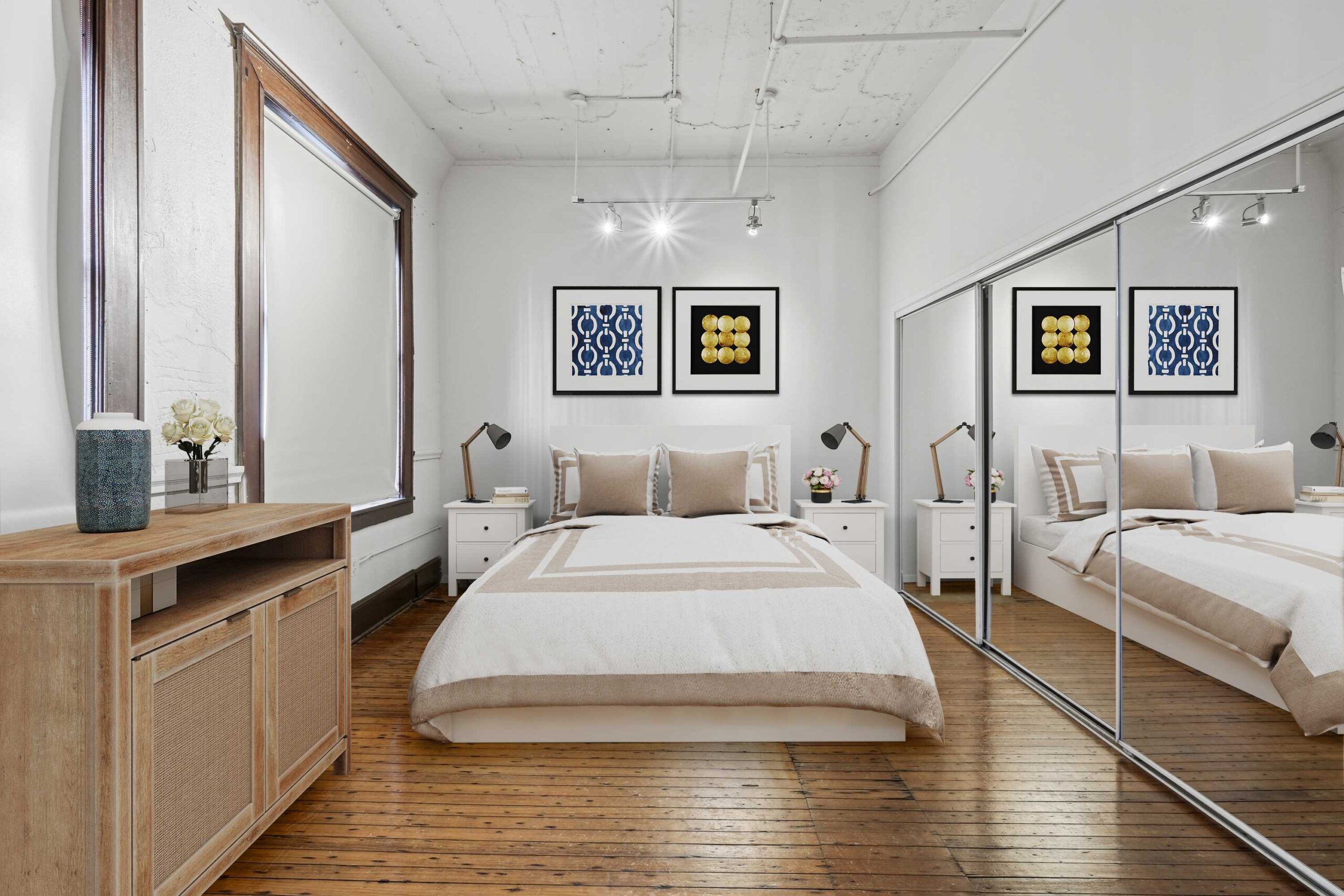 Bedroom with a sliding mirror closet door at in a boutique apartment at The Wilson in Dallas, Texas
