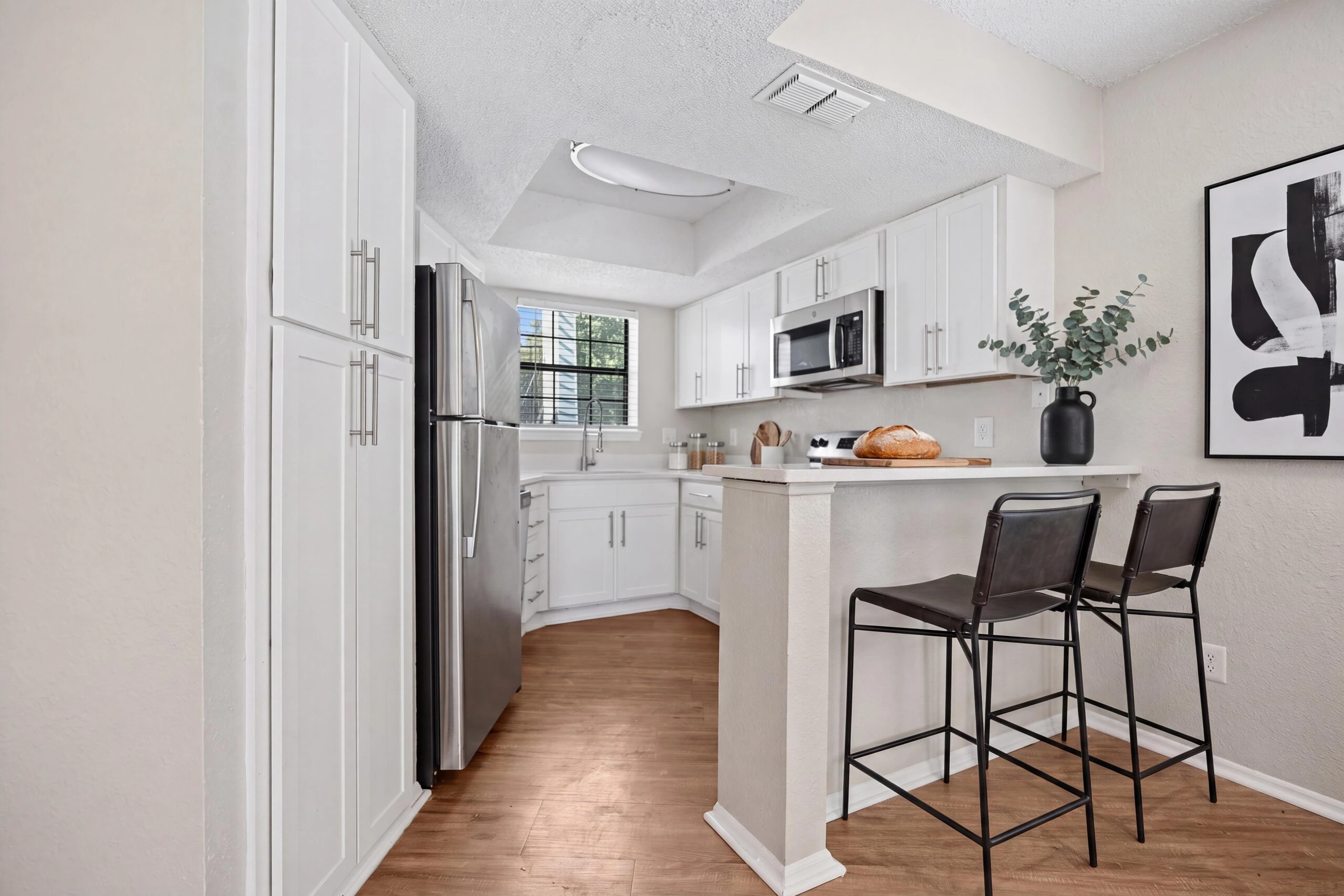 Kitchen with stainless steel appliances, granite countertops, and custom cabinetry.