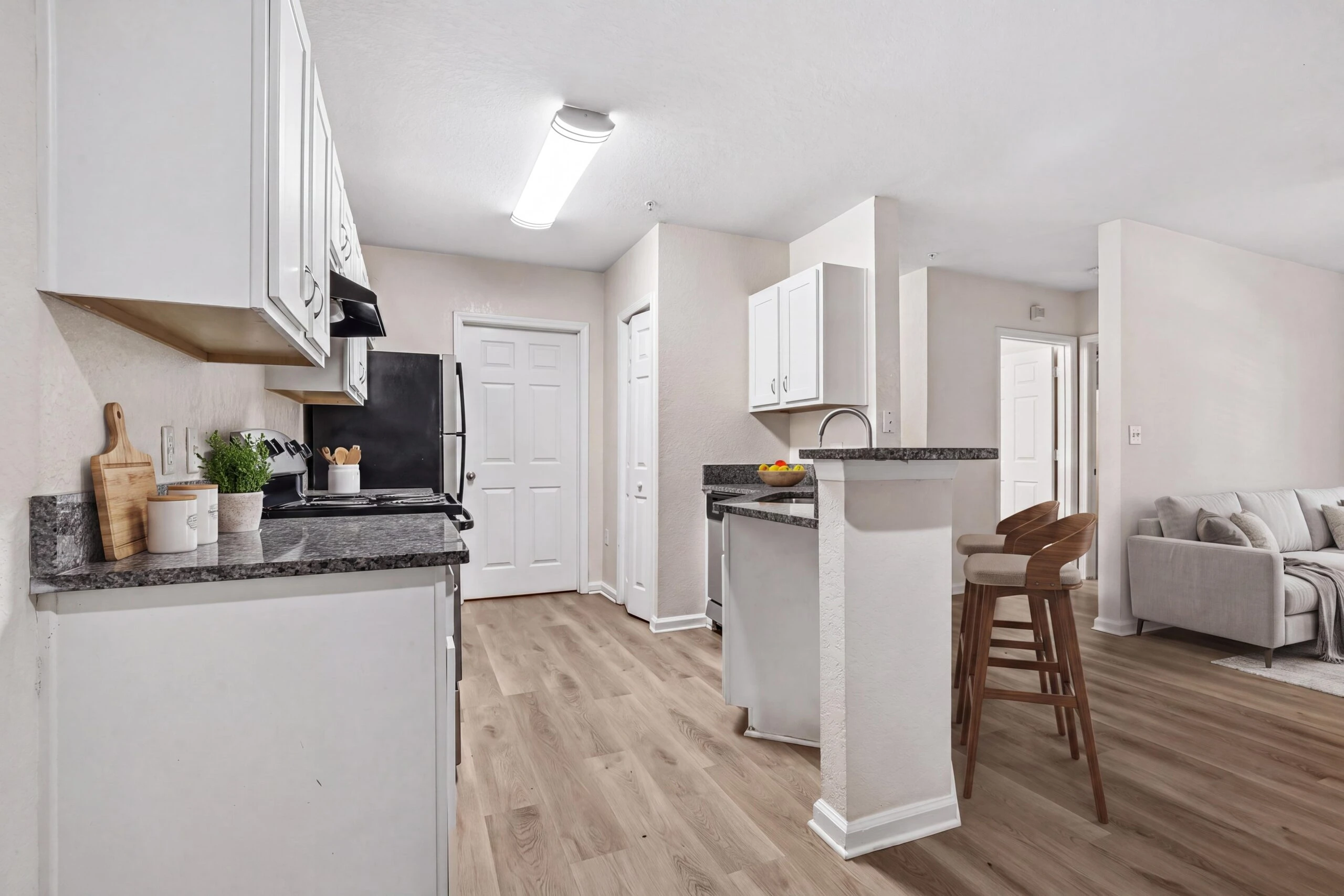 Modern kitchen with custom cabinetry, breakfast bar, granite countertops, stainless steel appliances, and more!