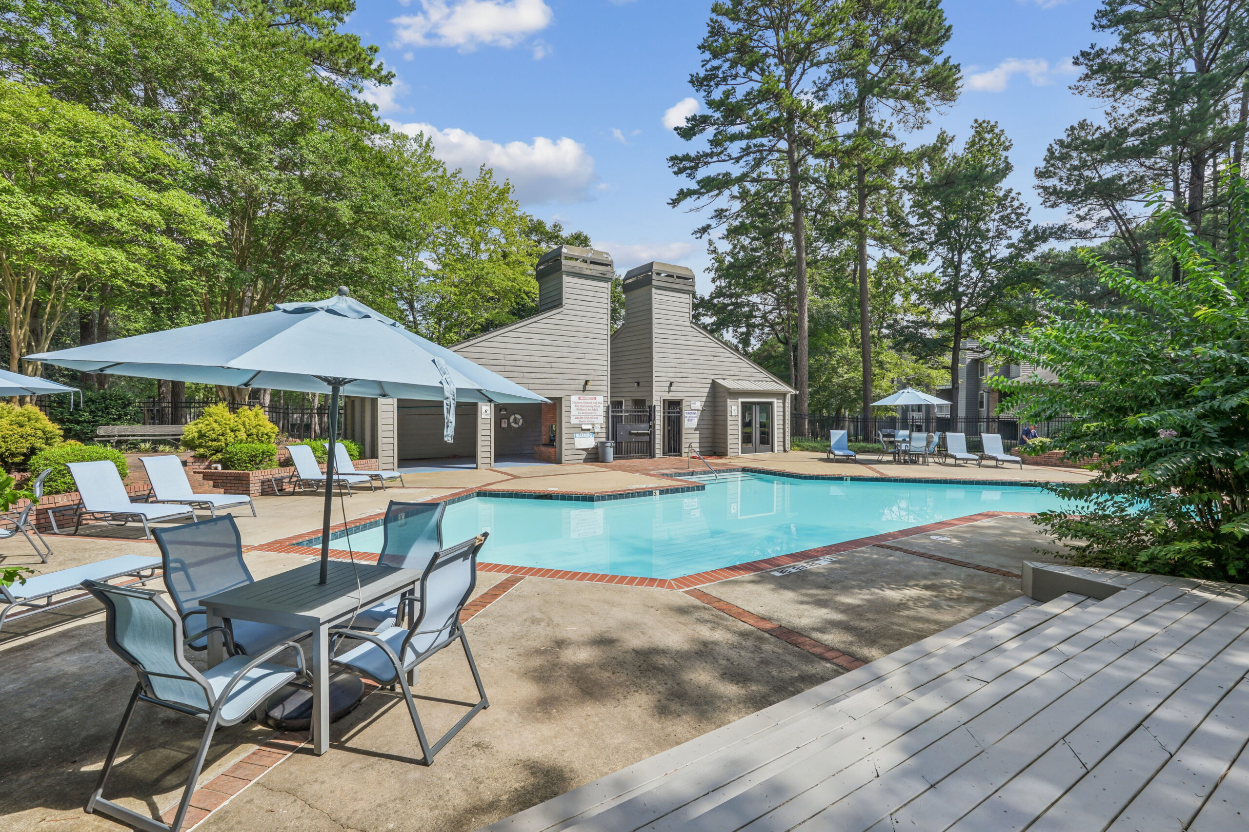 Sparkling outdoor pool with sundeck and lounge seating