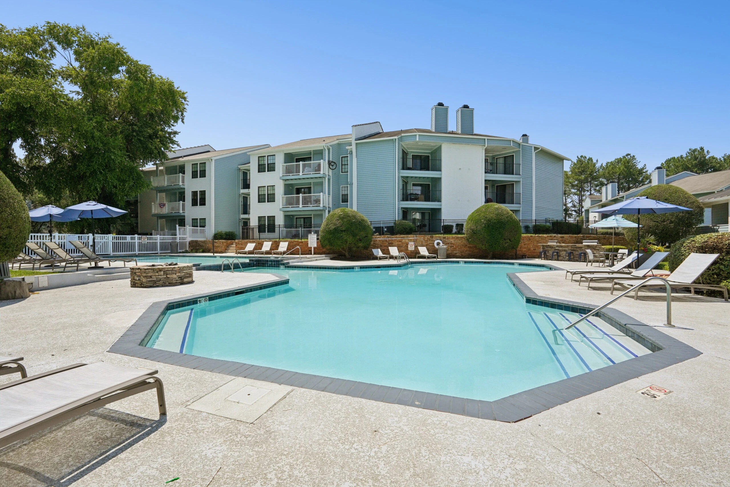 Sparkling outdoor pool with lounge seating