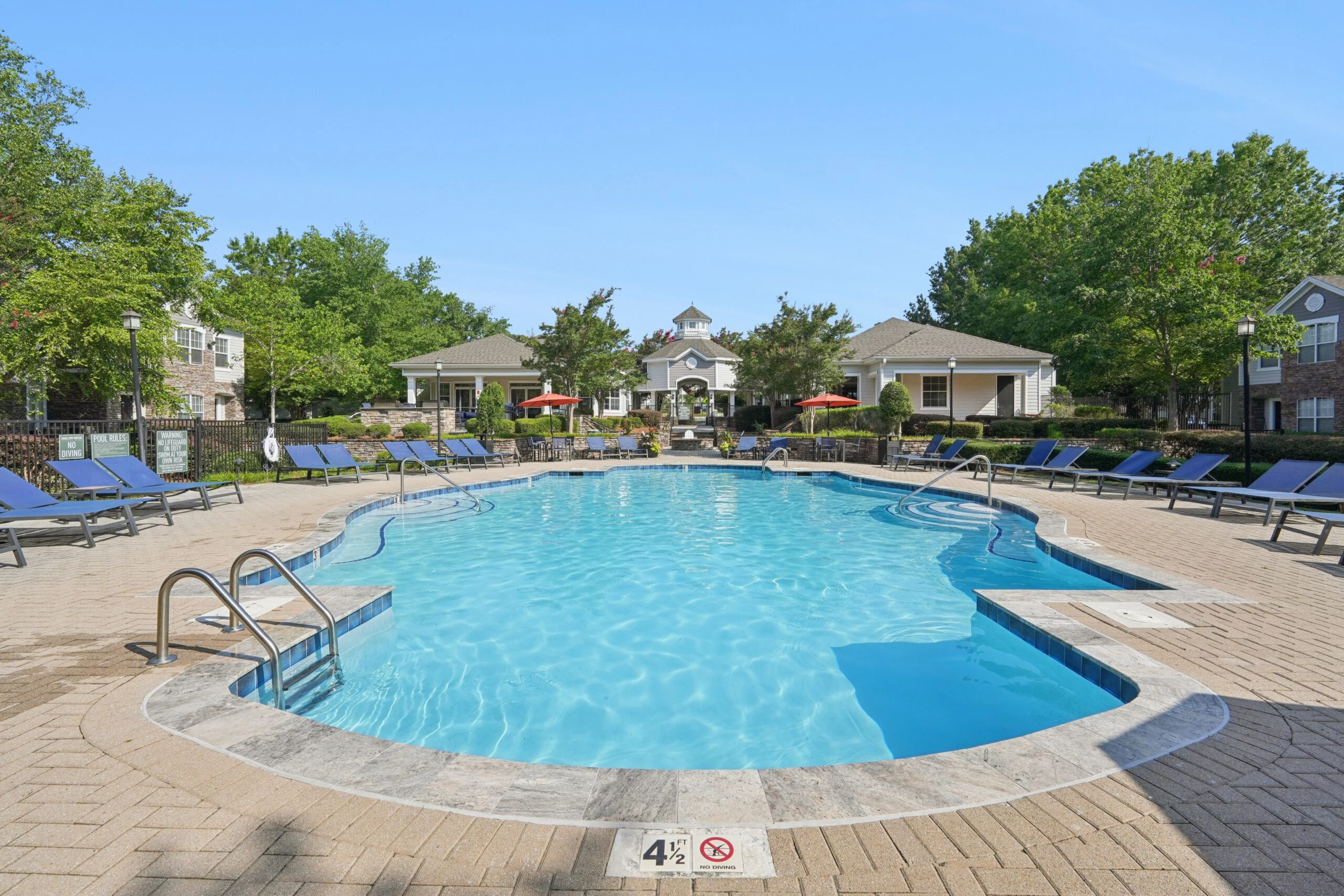 Resort-style outdoor pool with lounge seating